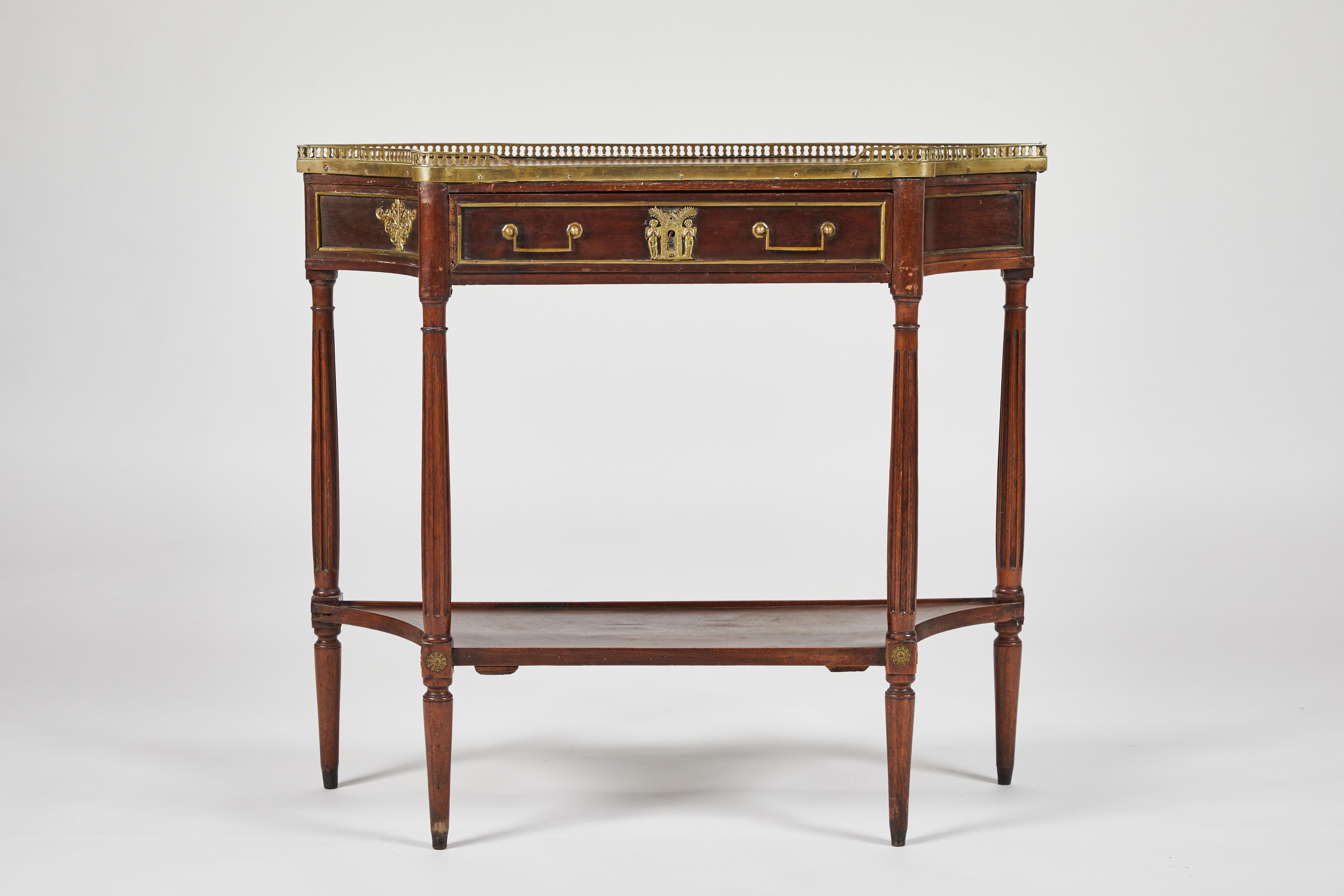 A Louis XVI style mahogany and mahogany-veneer console with beautiful ormolu mounts and brass gallery,
circa 1800.