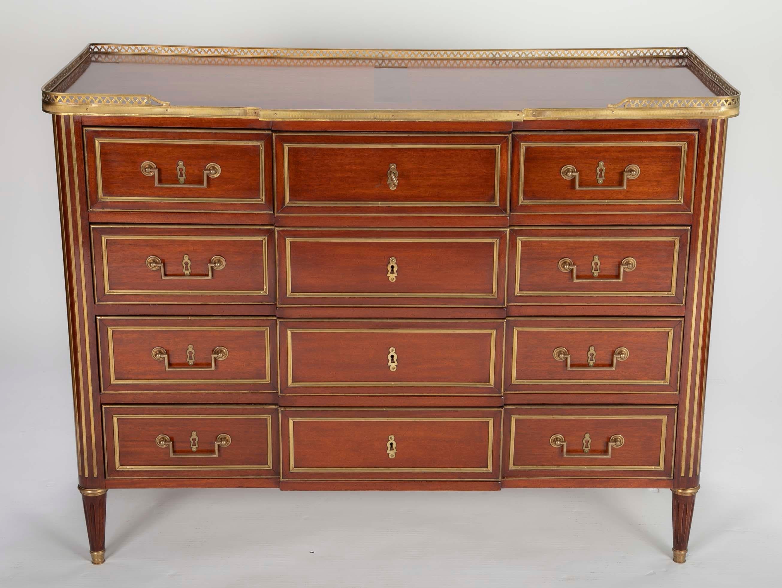 An early 20th century Louis XVI style mahogany chest with brass mounts and oak interior construction.