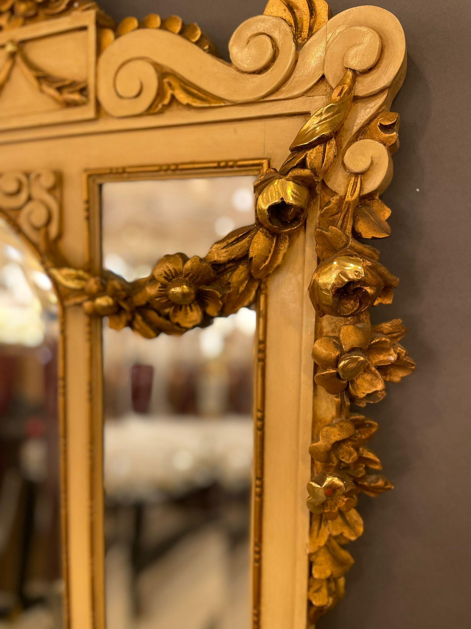 An elegant Jansens French Louis XVI style with a gilt-wood mirror, late 19 century. The entire mirror frame is hand-carved with intricate floral motifs, overlays and gilding. You can see the age of the piece in its characteristic patina. This mirror