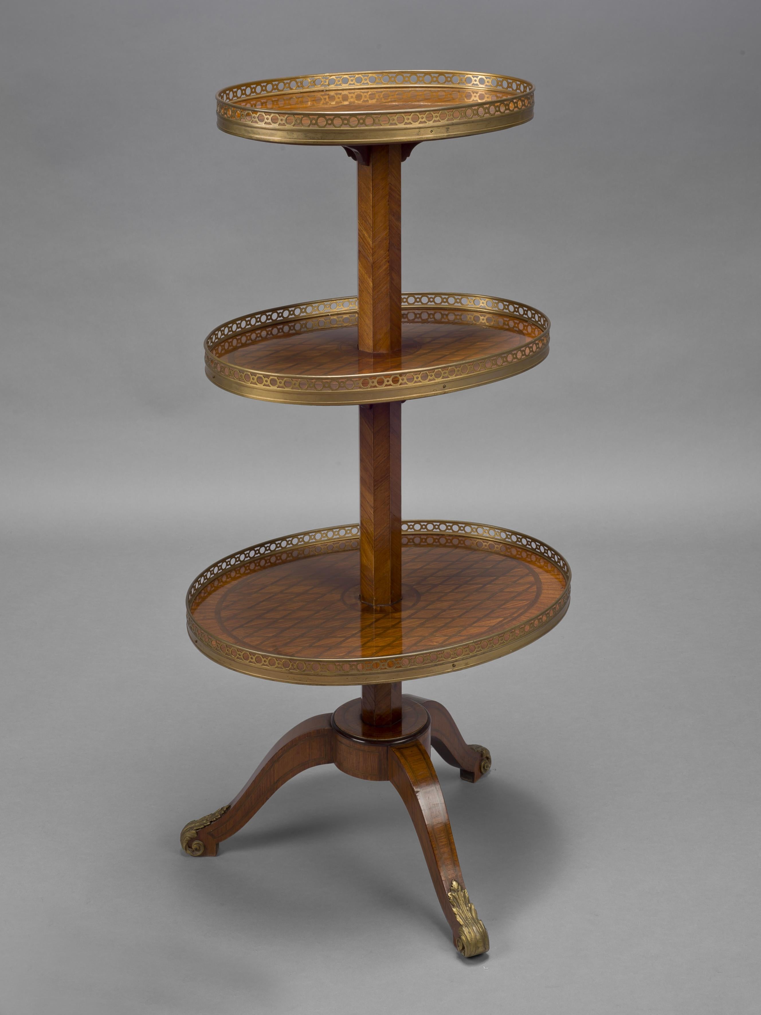 A Fine Louis XVI Style Oval Three Tier Gueridon
After The Model by Simon Phillippe Poirier and Martin Carlin. 

This fine and unusual gueridon has three graduating oval shelves surmounted by a pierced gallery and supported by an octagonal central