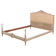 A Louis XVI style painted and gilt carved wood bed, C. 1930.