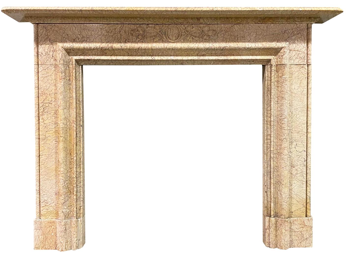 This antique fire surround is constructed from Rosa Valencia marble and features a carved frieze panel. It was reclaimed from a house in Ascot.