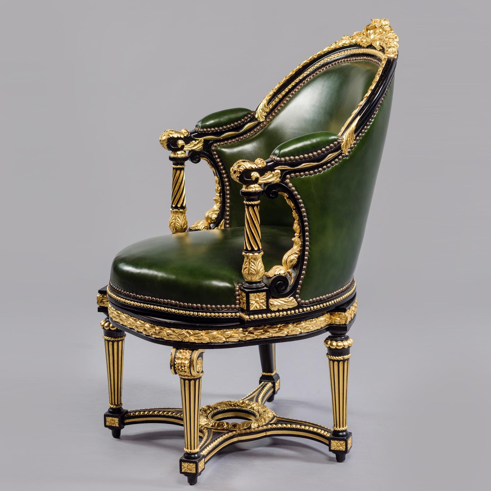 A Louis XVI Style Gilt and Ebonised Carved Rotating Desk Chair Upholstered in Green Leather.

Of tub form this comfortable rotating desk chair is finely carved with flowers and foliage and upholstered in green leather. It is raised on four tapered