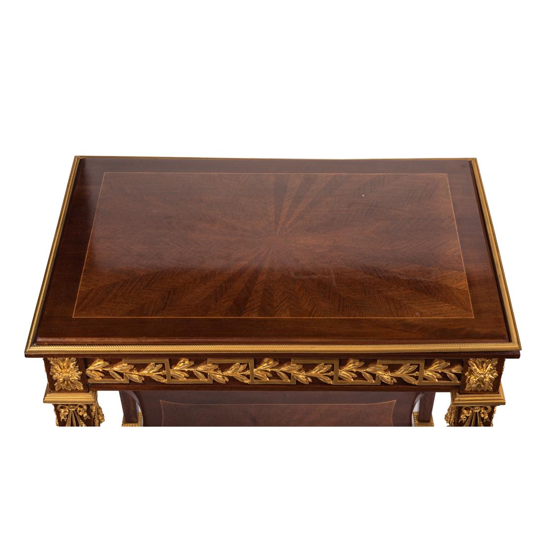 A Louis XVI style table in solid amaranth with gilt bronze mounts, containing a frieze drawer,
Measures: Height 19.5 in. (49.53 cm.)
Width 24 in. (60.96 cm.)
Depth 16 in. (40.64 cm.)