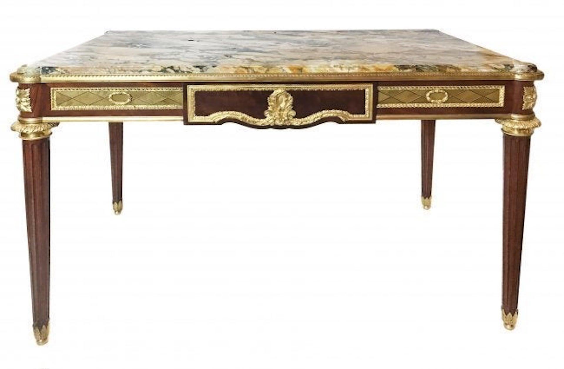 A Louix XVI style gilt-bronze mounted mahogany center table 
Paris, circa 1890
surmounted by a Sarrancolin marble top with rounded corners above a long single frieze drawer and raised on fluted tapering legs, the frieze similarly decorated on the