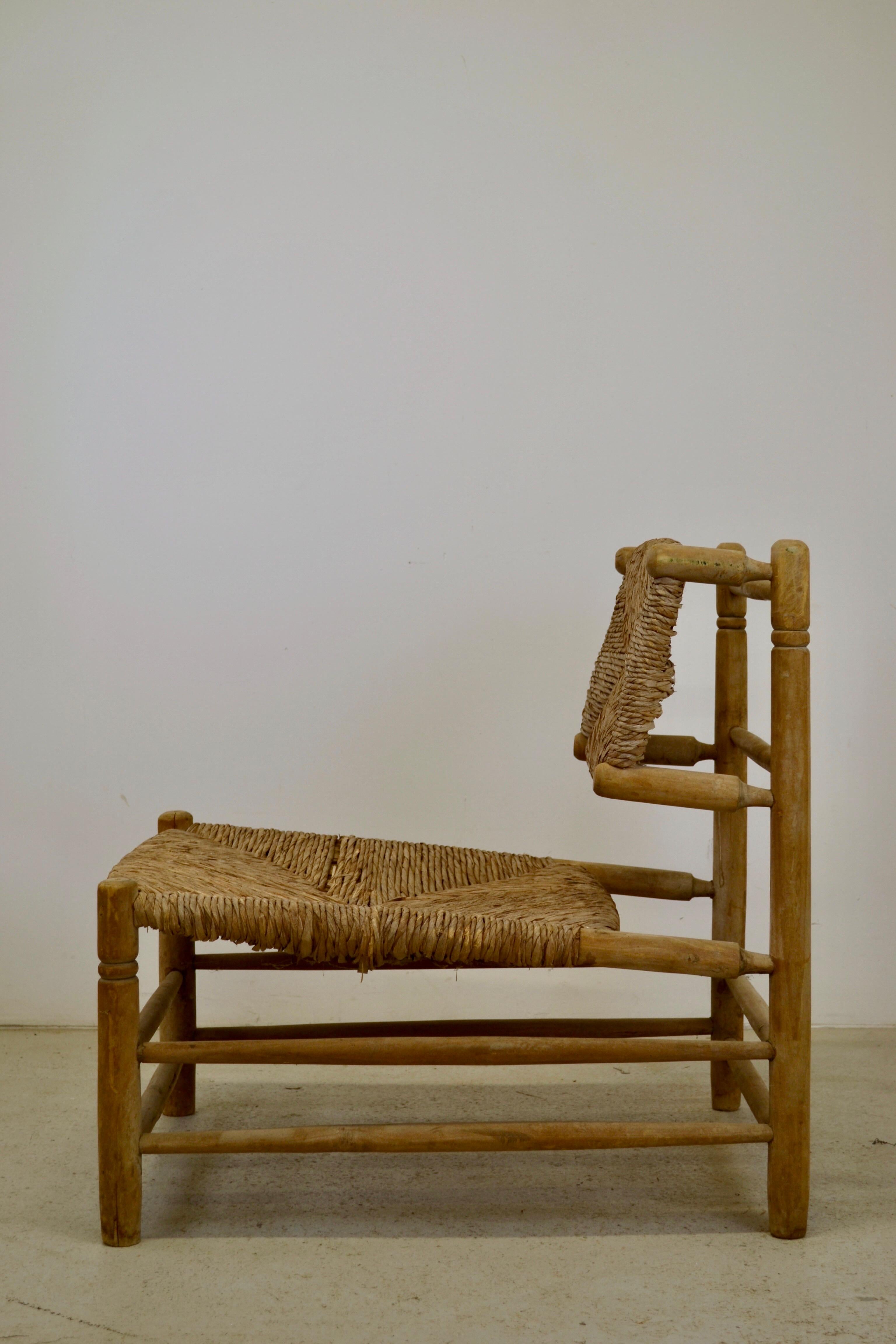 A superb lounge chair from France, 1950s. In good original condition with the original straw seat and back. Fast shipping worldwide. Some minor wear on the seat to note, but it has a beautiful patina.
