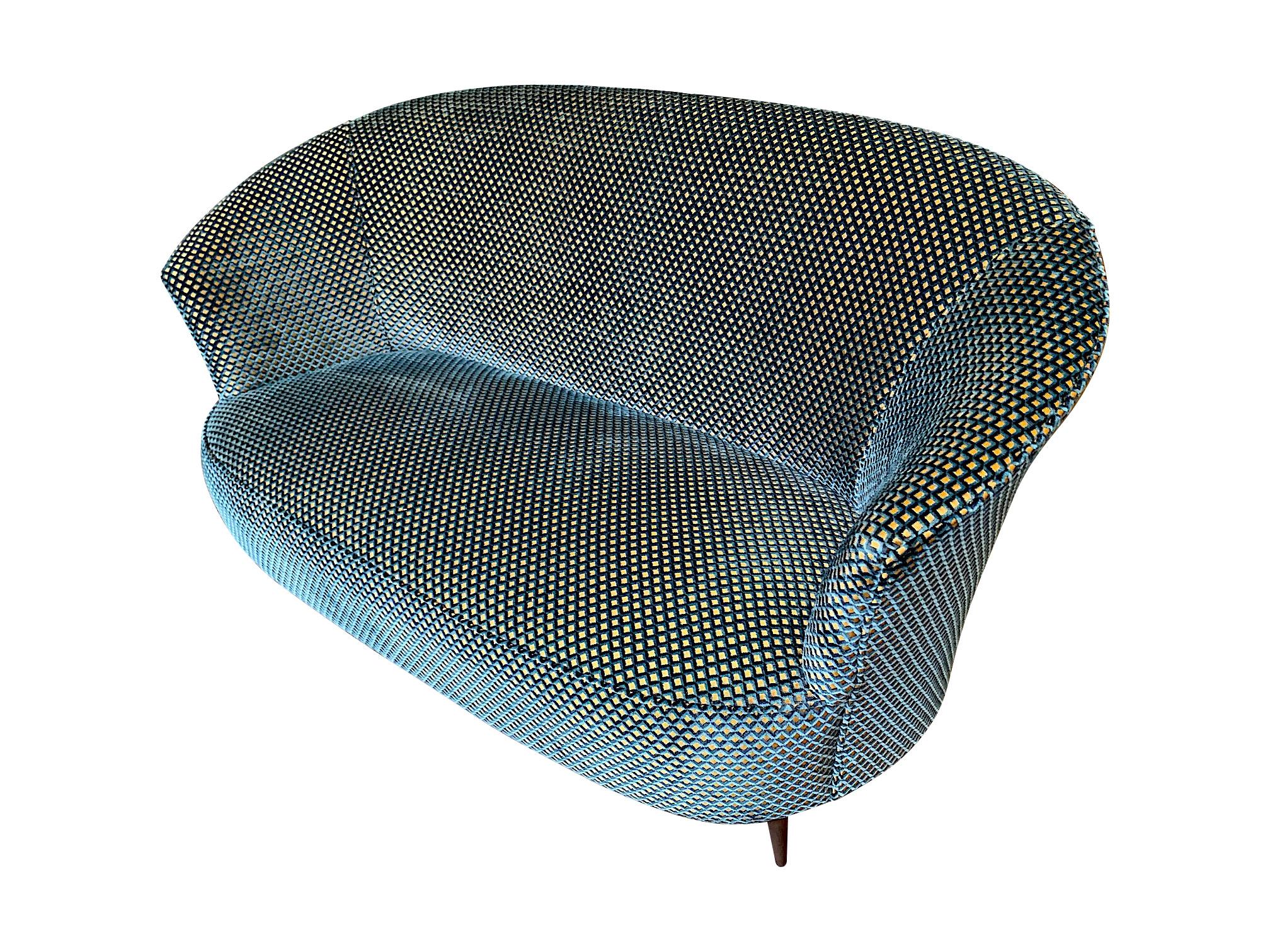A lovely 1950s Gio Ponti style Italian two-seat sofa with original shaped wooden legs. Newly reupholstered in designer guild blue velvet and gold fabric.