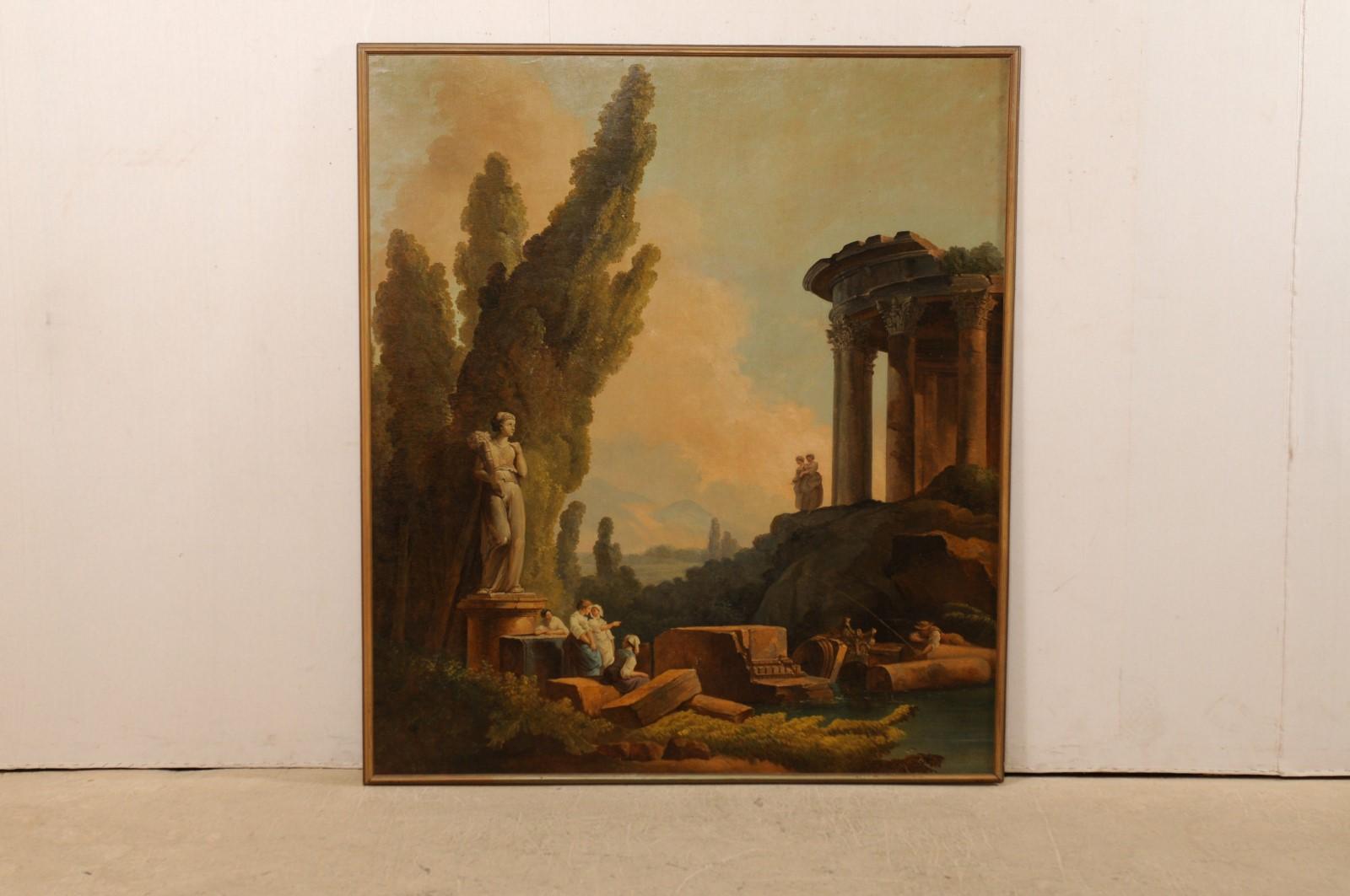 An Italian large-sized painted wall panel from the 19th century, artist unknown. This antique artisan painted and framed wall panel from Italy is a lovely capriccio depicting a classical Romanesque ruins landscape animated with maidens gathering and
