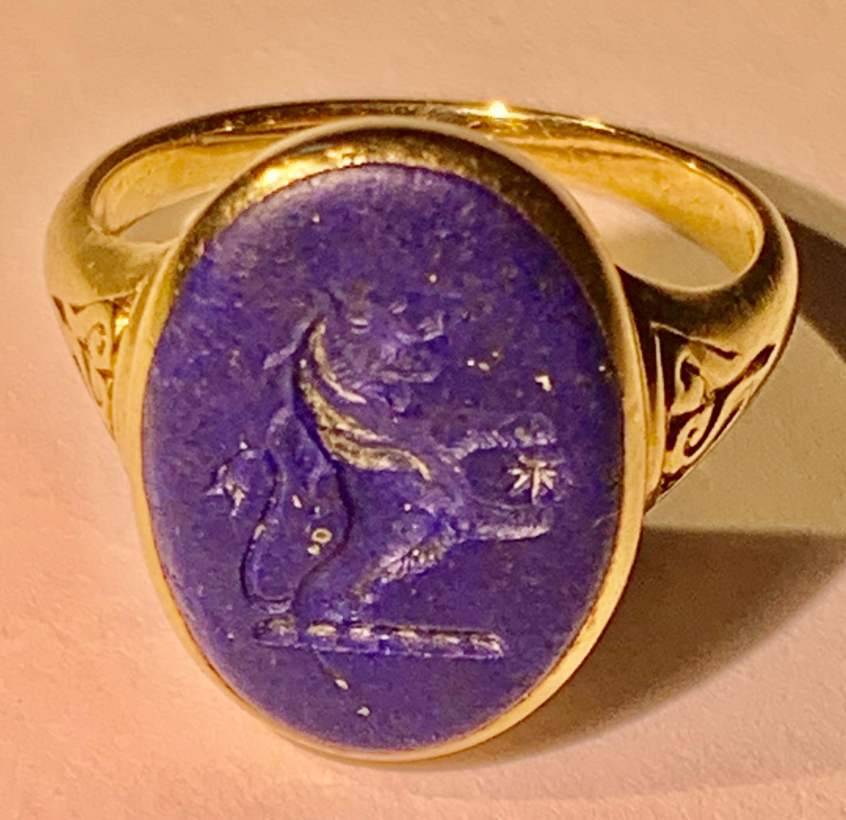 A Lovely Antique signet ring, set in 18K yellow gold.
Beautiful well-detailed crest, a nice unisex ring with stylish heart shape design on the shoulders, this features a lapis lazuli intaglio of an excellent purplish blue colour with some fine