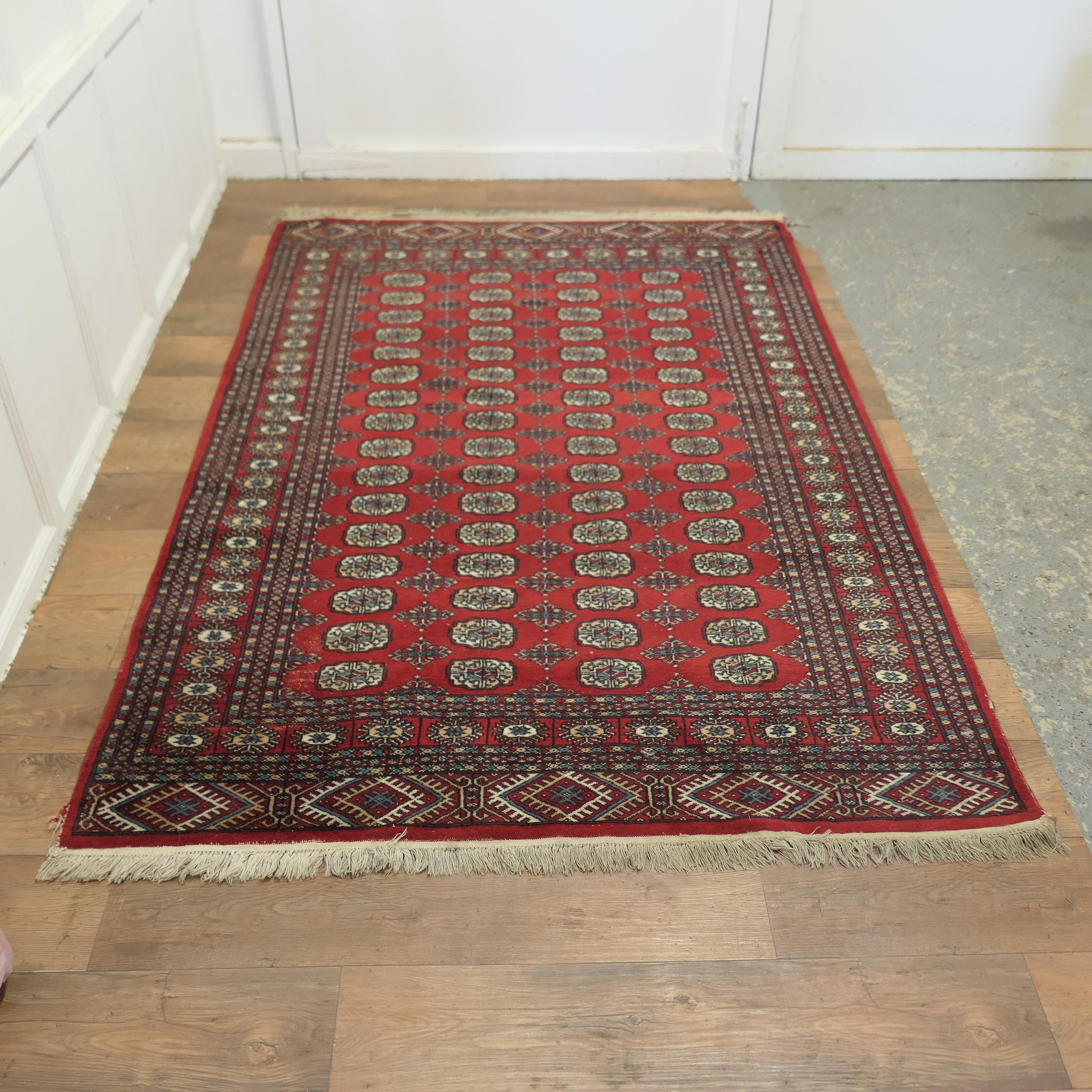 A Lovely Bright Red Wool Rug

The Carpet is a wonderful Bright colour with an attractive pattern and a wide border, there is little wear to the selvage edge at one end and a slightly bare patch at the other
This rug is from the middle of the 20th