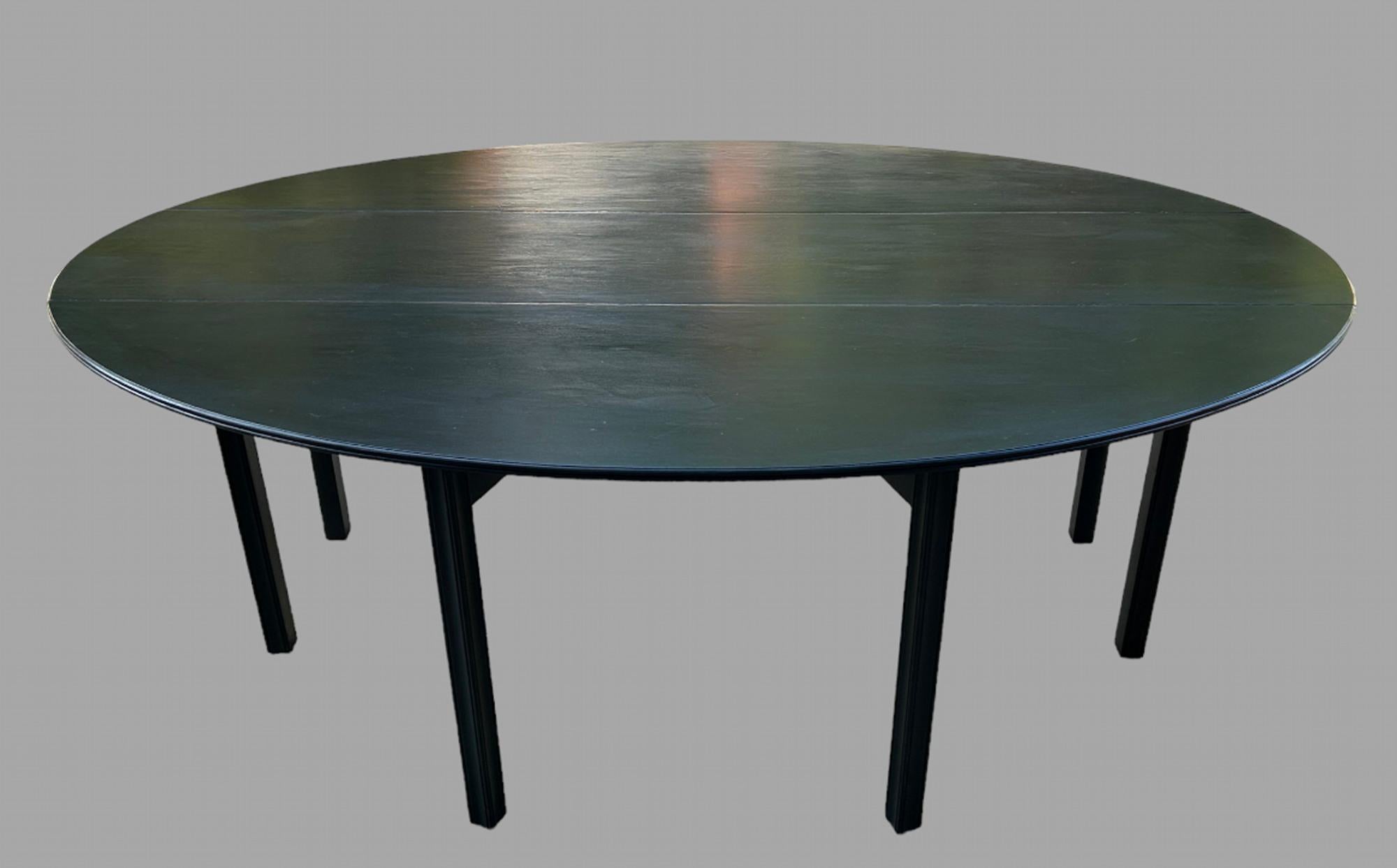A Lovely Painted Oval Mahogany Gateleg Table in liberty black that would seat eight comfortably with very good knee height. Ideal as both sides fold down or you can just put one up.