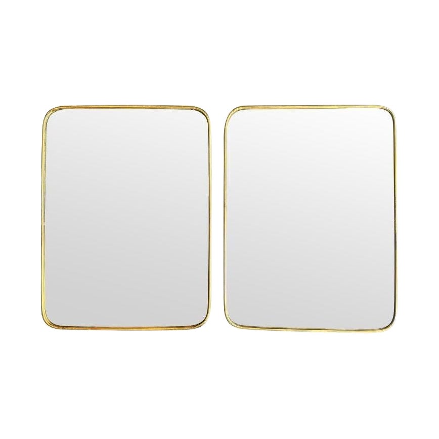 A lovely pair of 1950s Italian brass framed mirrors with solid wood backs For Sale