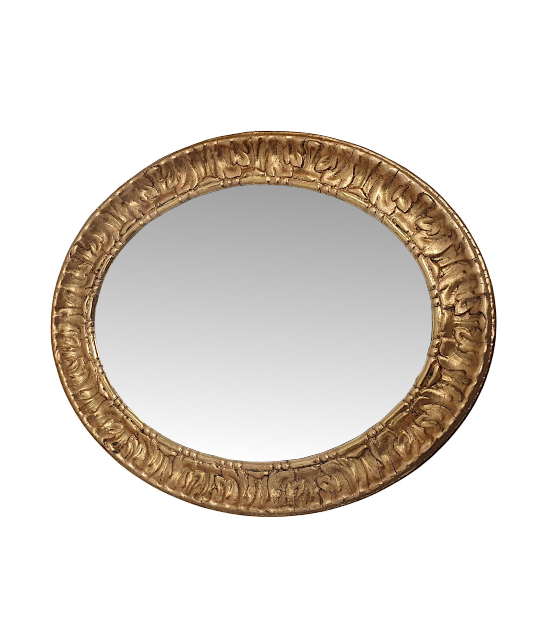 A lovely pair of 19th Century giltwood mirrors, finely hand carved, fully restored and of exceptional quality.  The bevelled mirror glass plate of oval form is set within a fabulous moulded giltwood frame with elegantly simple lozenge and bead