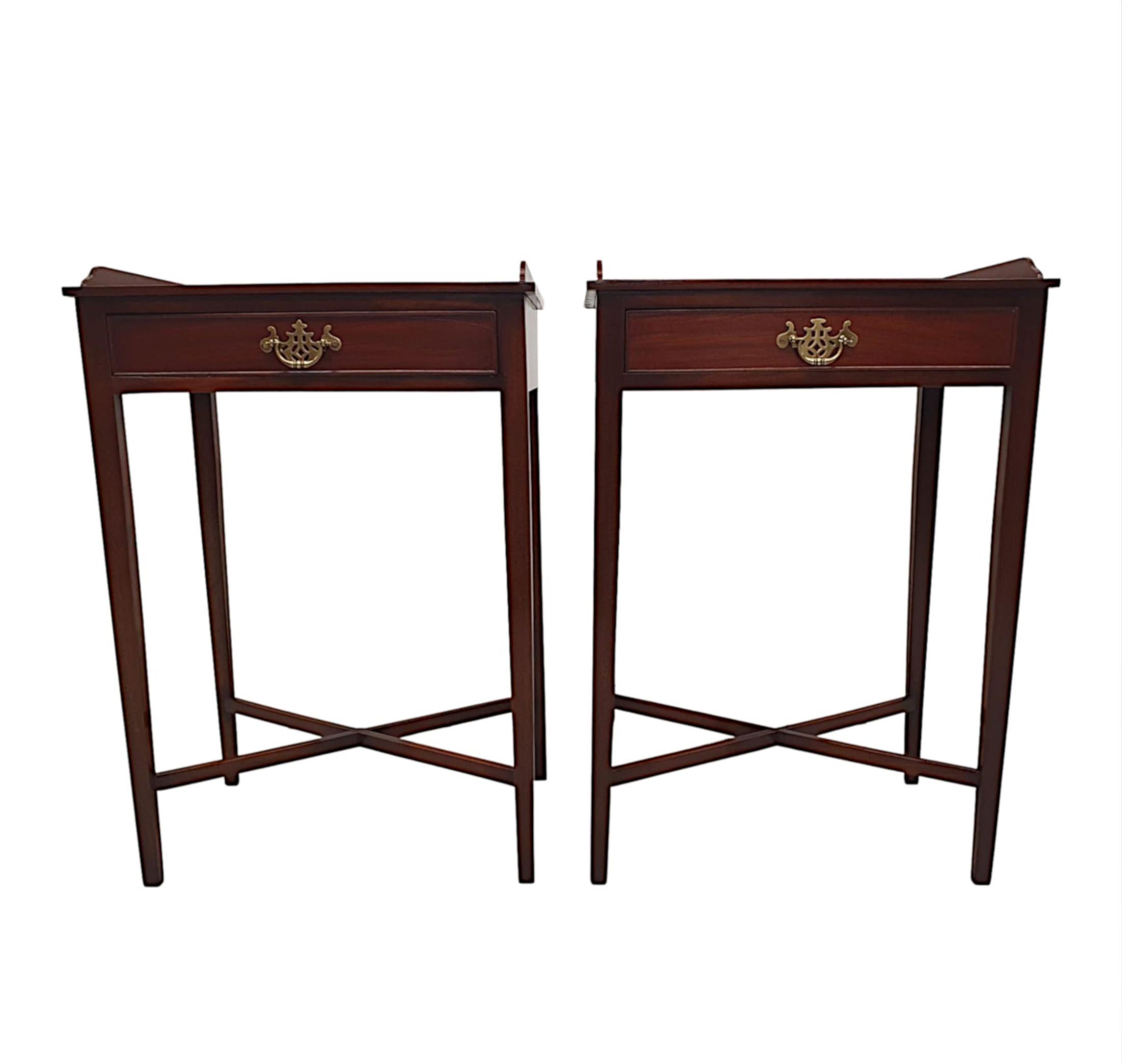A lovely pair of 20th century mahogany side tables, hand carved with a beautifully rich patination and grain. The moulded top with 3/4 gallery rail is raised over single drawer frieze, cockbeaded with decorative brass swan neck handles, supported on
