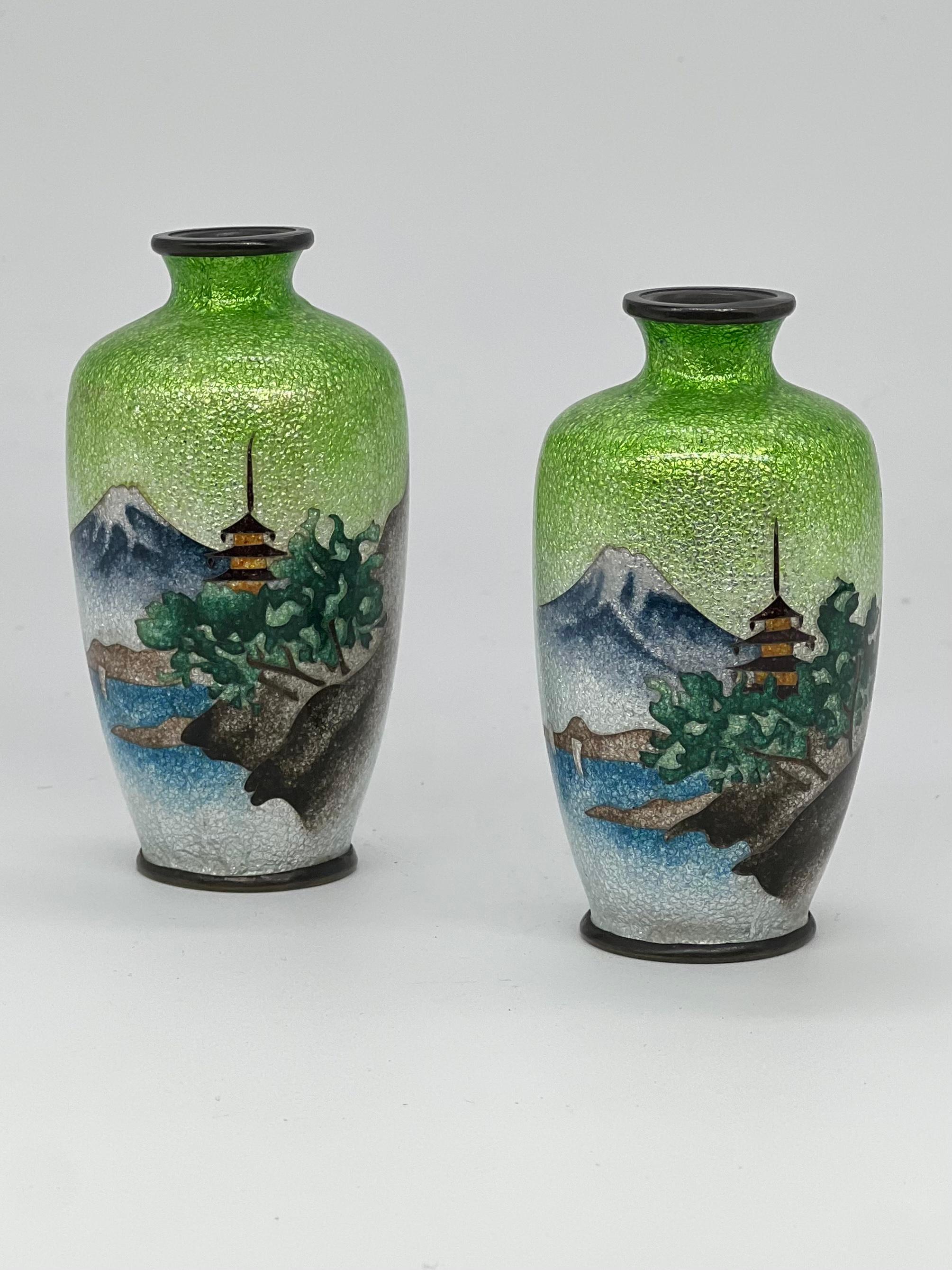 A Lovely Pair of Antique Meiji Period Japanese Ginbari Cloisonne vases. 19th C

A Fine pair of Japanese Ginbari cloisonne vases , Meiji period (1868-1912), worked with a silver wire and decorated with a pagoda with landscape of mt. Fuji, river and