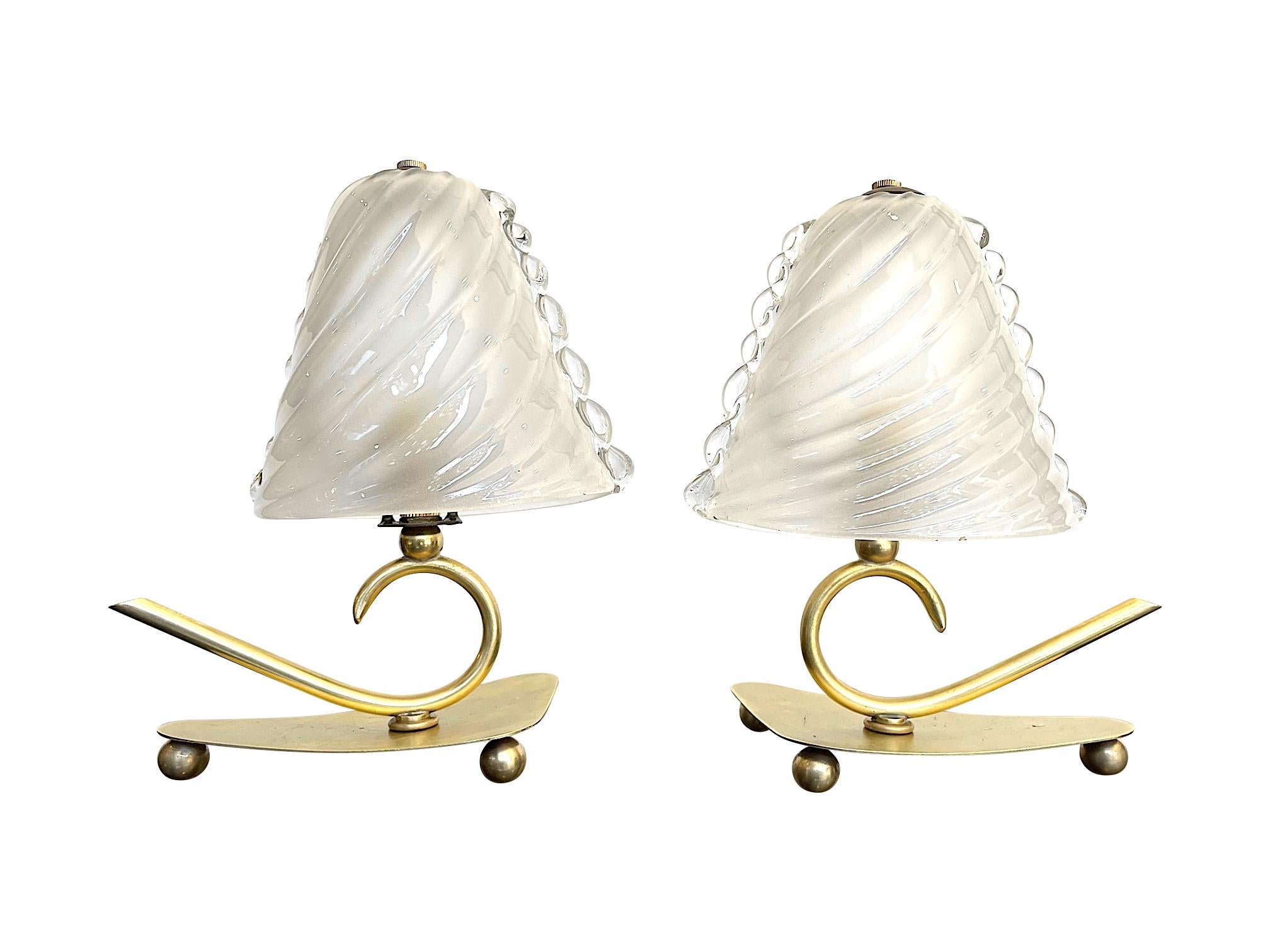 A lovely pair of Barovier 1960s Italian lamps with twisted Murano glass with shade scolloped edges. Mounted on A brass base with decorative curved stem on brass spherical feet. Re wired with new brass fittings and antique cord flex and PAT tested.