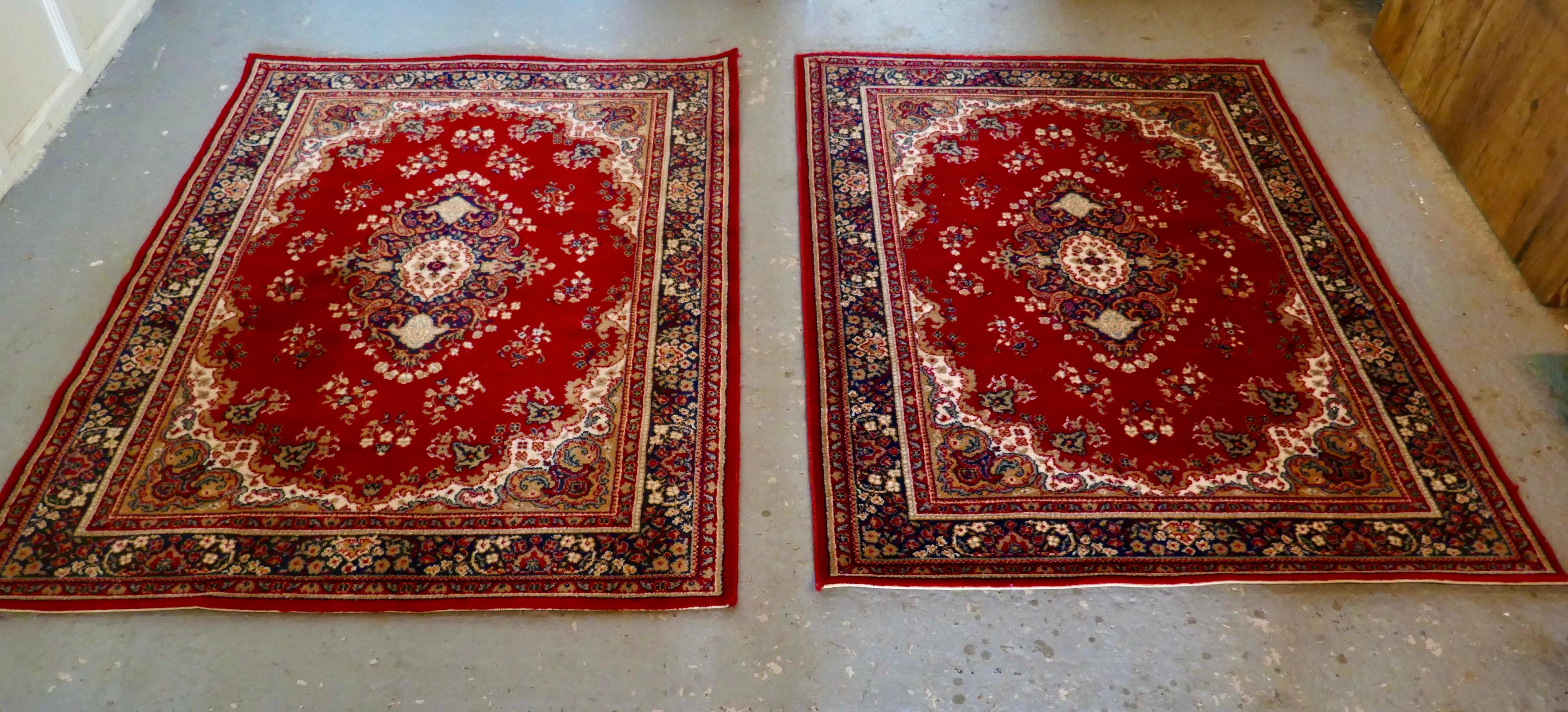 A lovely pair of bright red wool rugs

The carpets haves a wonderful bright colour with an attractive pattern and a wide border, they are both 1n good all round condition
This rugs are from the middle of the 20th Century they measures 66” x 48”