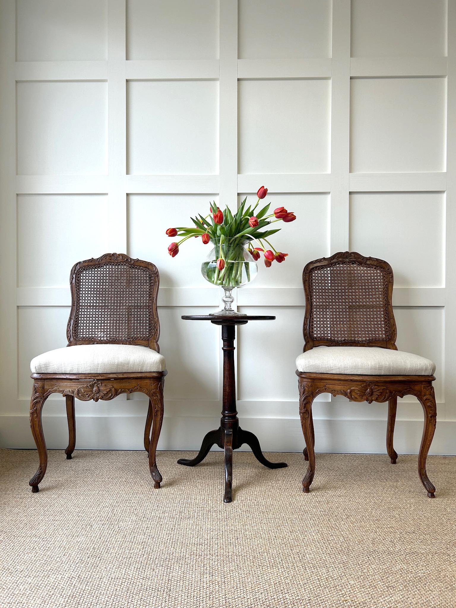 A truly delightful and charming pair of early 19th century French salon chairs. With original caned back splats.  Newly upholstered in fresh Kravet 100% linen. The silhouettes are stunning! Lovely carving, look at the beautiful sunburst pattern on