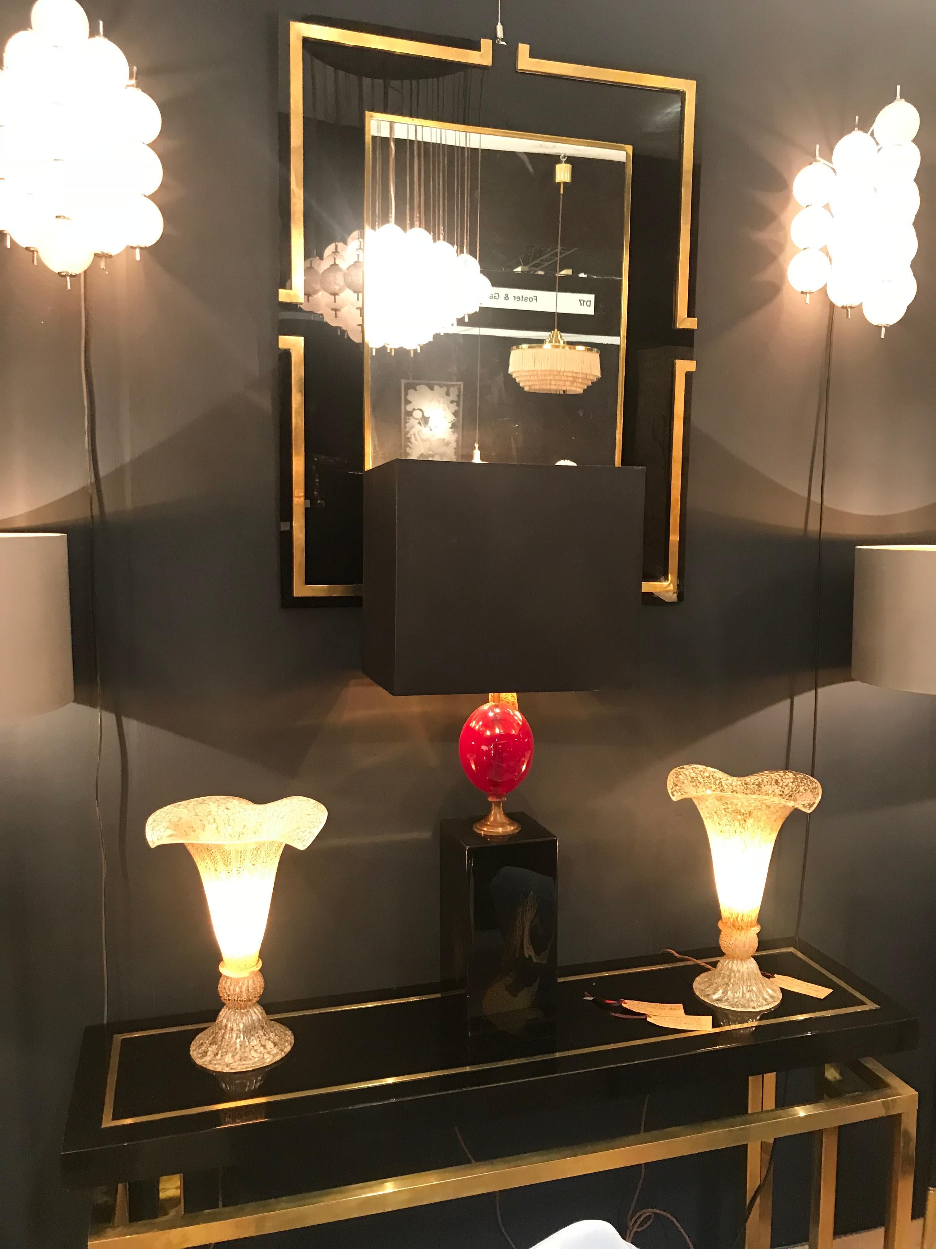 A lovely pair of Murano glass fluted lamps with mottled ribbed finish of black, white, clear and gold glass. Re wired with new brass fittings and antiques cord flex and PAT tested.

   