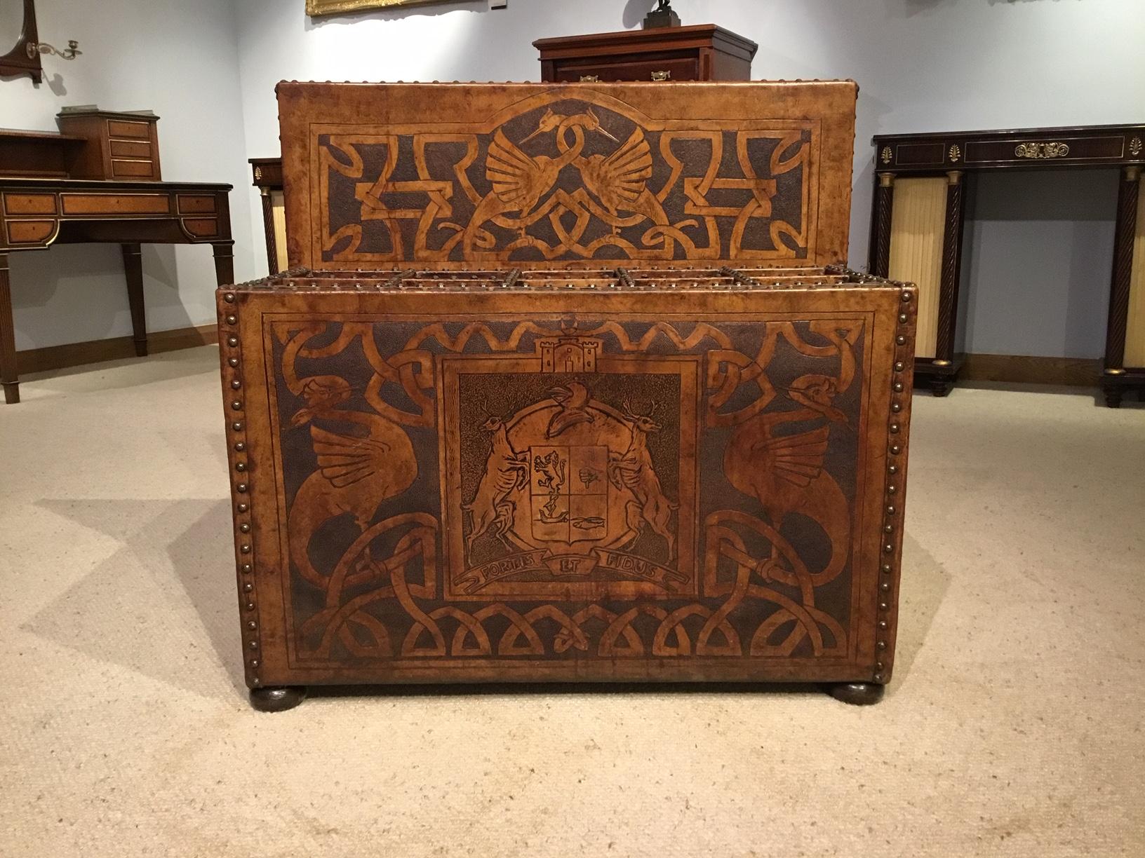 A lovely & rare country house leather umbrella/walking stick Stand. Having a raised back with brass studded detail with an embossed panel depicting entwined Griffins above ten divisions for umbrellas/walking sticks. The front and sides with similar