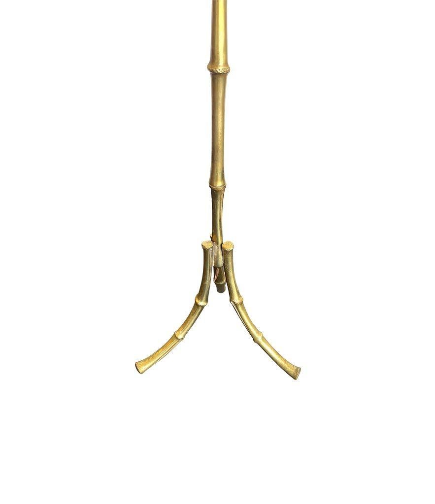 A Maison Bagues faux bamboo brass floor lamp with three legs. Re wired with antique gold cord flex and PAT tested.