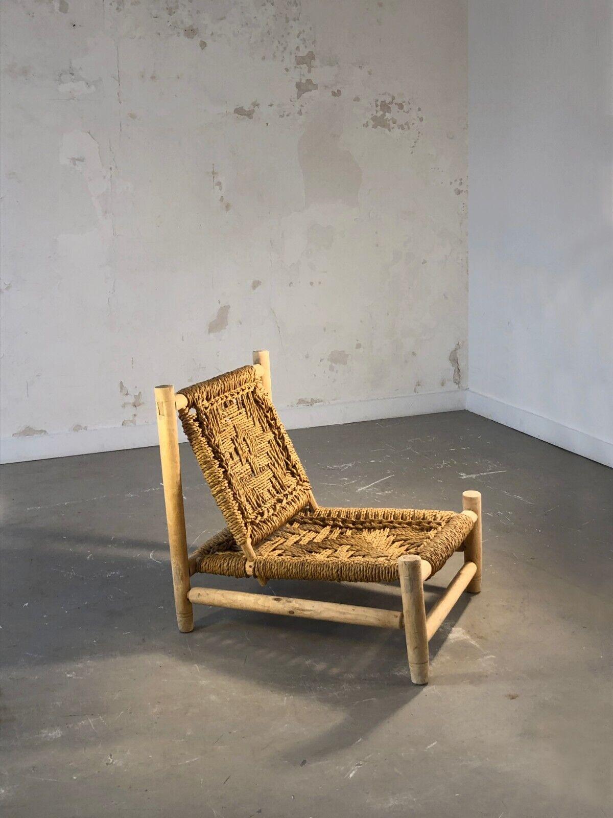 A small low armchair in clear wood and rope, Modernist, Constructivist, Brutalist, Rustic Modern, structure in cylindric light and dry wood holding a seat and a back woven in rope with a geometric motiv, by Adrien Audoux & Frida Minnet aka
