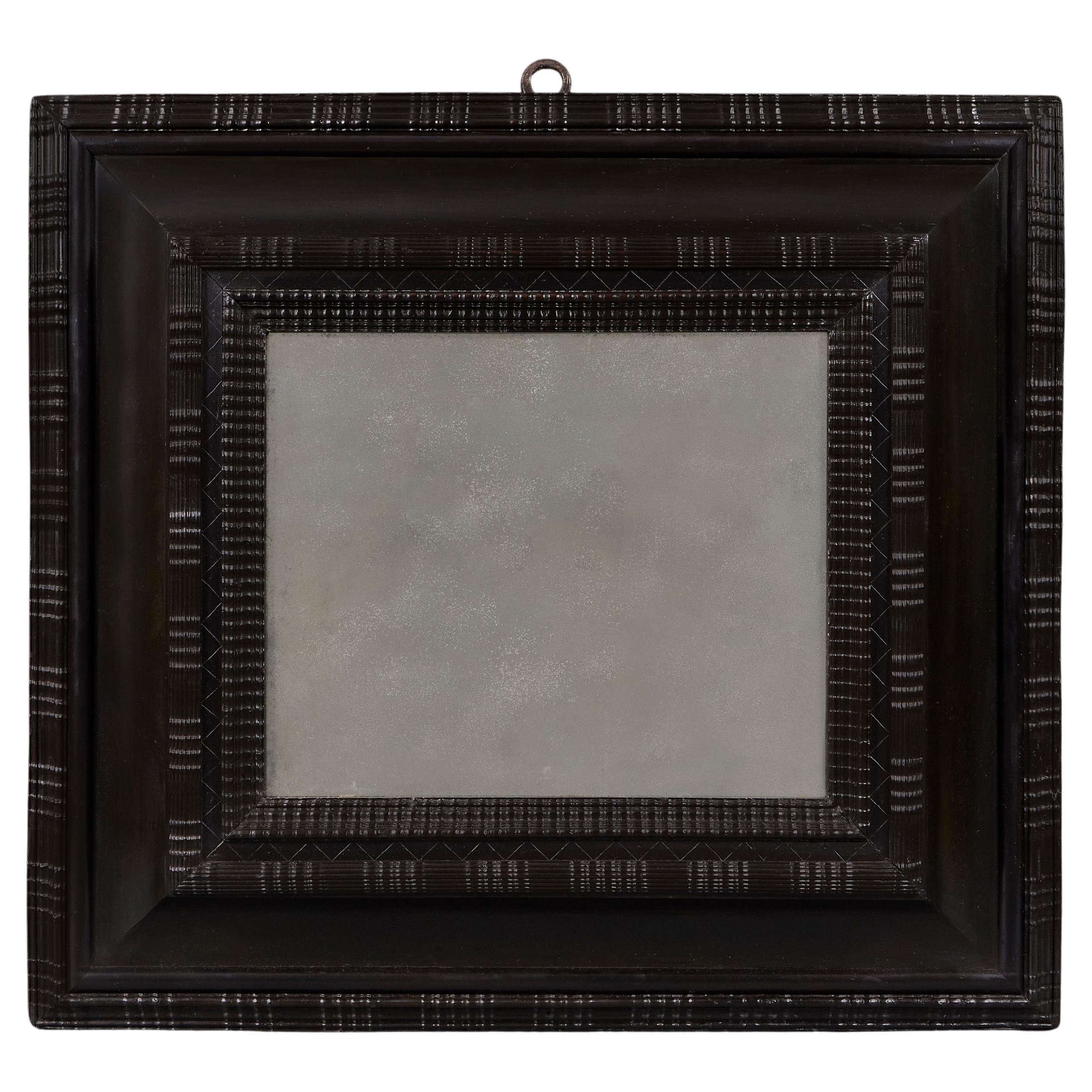 A Low Countries Deep Ebony Ripple Moulded Cushion Mirror For Sale