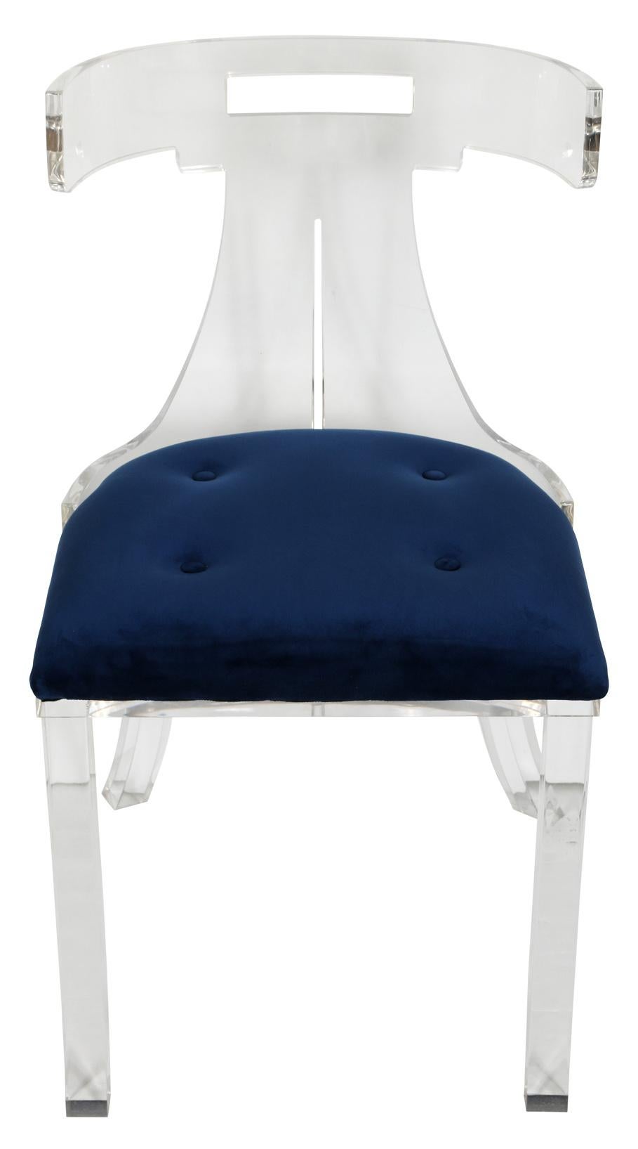A sleek and chic side chair in lucite, with a blue upholstered seat. Although it looks light and airy, the chair has some weight to it. It would make a perfect desk chair.