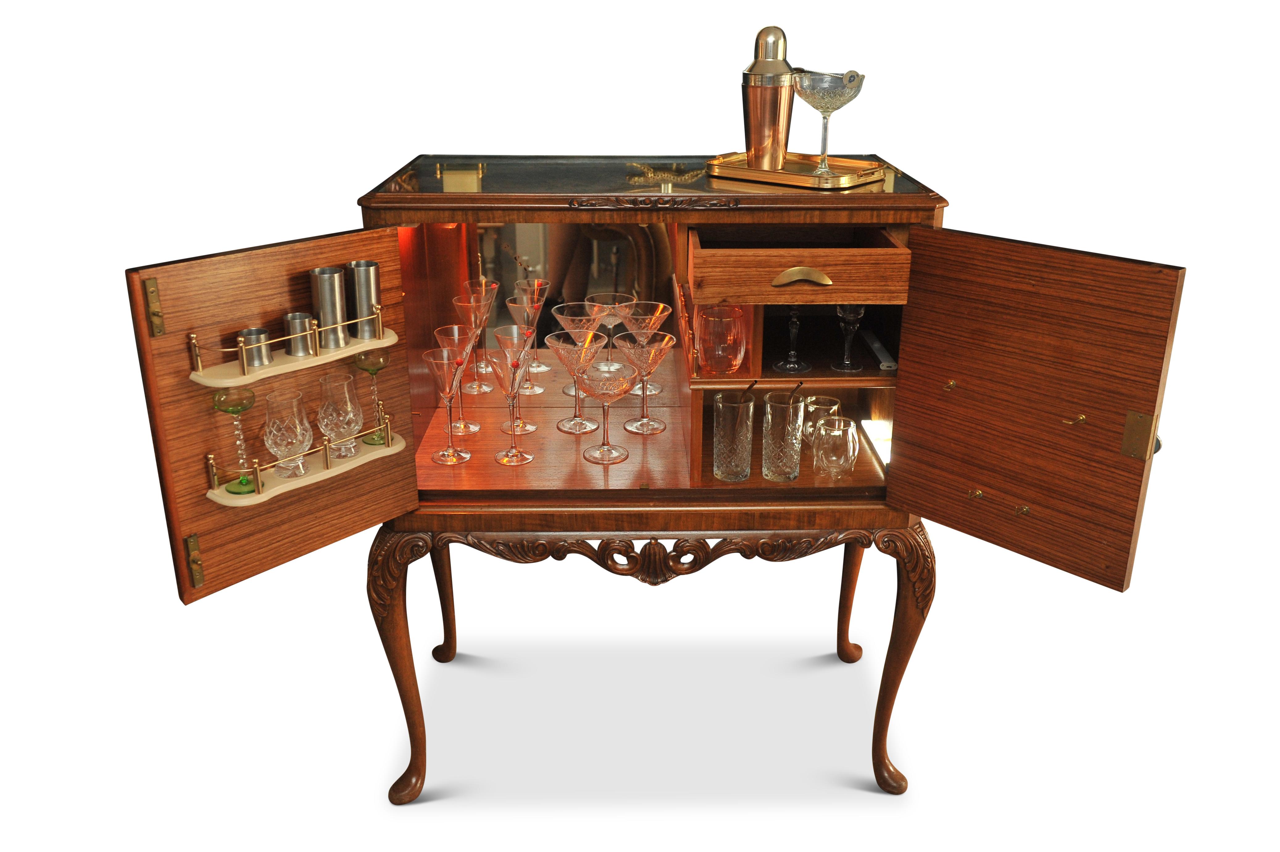 A Luxurious Burr Walnut Cocktail Cabinet With A Fitted Light, A Mirrored Interior & Glazed Secured Top. 

Cabinet is fitted with an internal working light, which has a UK three pin plug (not PAT tested).

Inside features a well made dovetail drawer