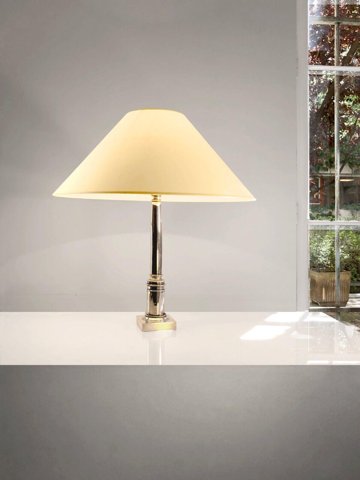 An elegant and luxurious table lamp, Art-Deco, Neo-Classical, Shabby-Chic, re-interpretation of an antique column topped with a beautiful lampshade, in silvered bronze, punctuated with some golden details, to be attributed, France 1970 .

In the