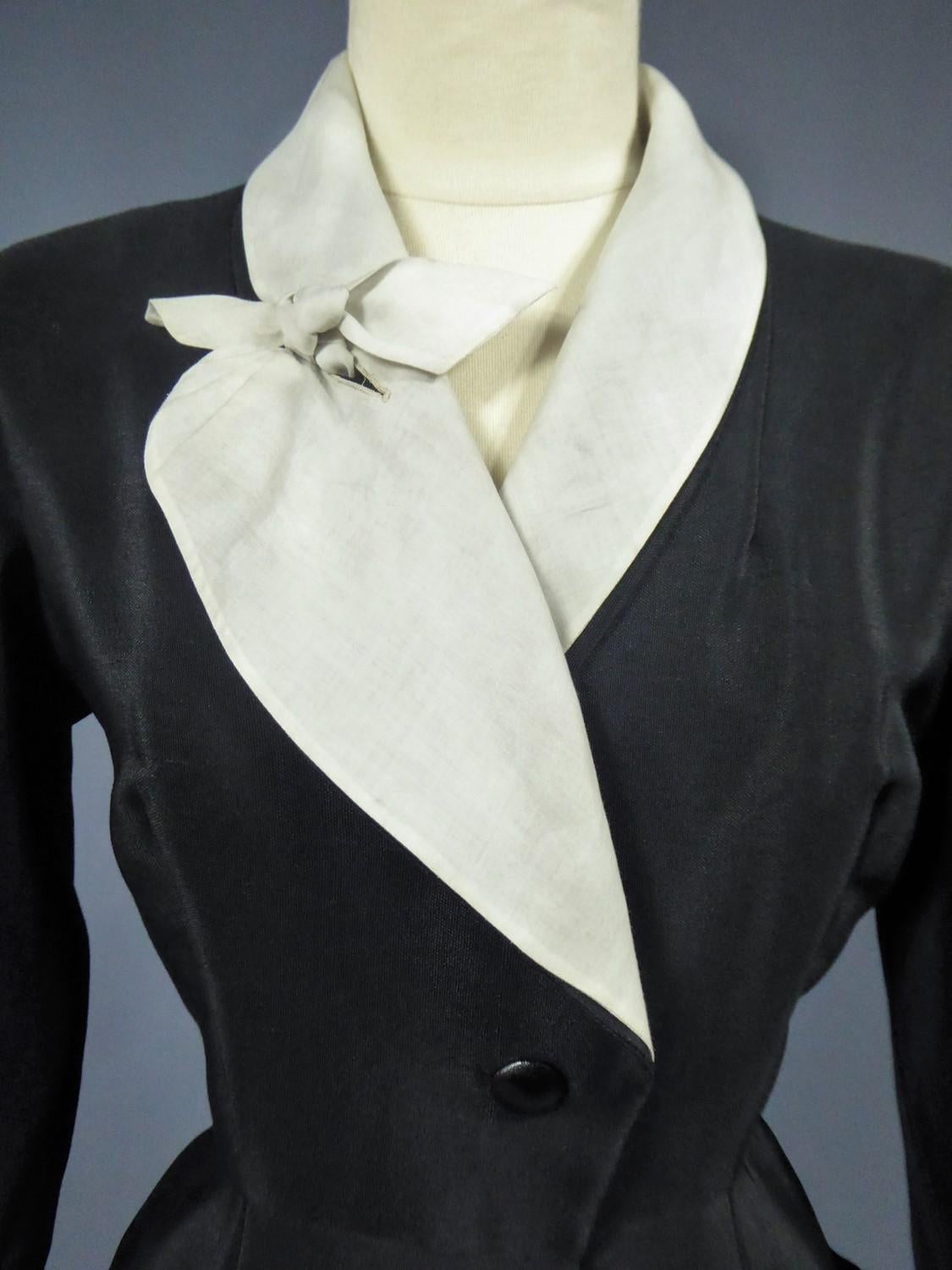 Circa 1950

France Paris

Cocktail or dinner dress in black silk ottoman from the famous designer house Maguy Rouff around 1950. Dress called Redingote, open and buttoned in front, mid-length at 35 cm from the ground like the designer house Worth