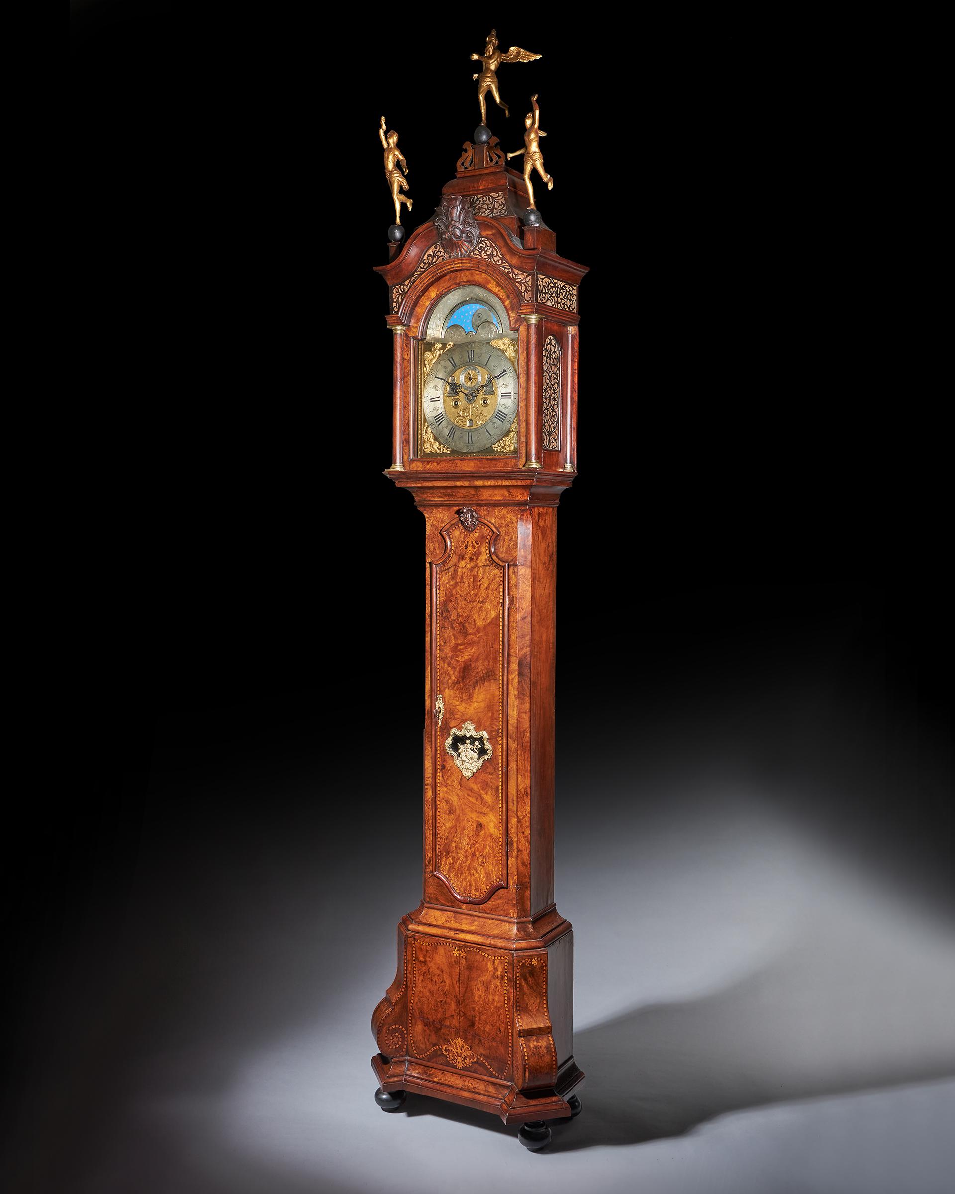 An impressive Dutch longcase clock with a burr walnut veneered oak case, signed on the chapter ring Pieter Brandt Amsterdam, c. 1745-50. The hood of this clock has a broken arch top pediment with very fine elaborate fretwork functioning as sound
