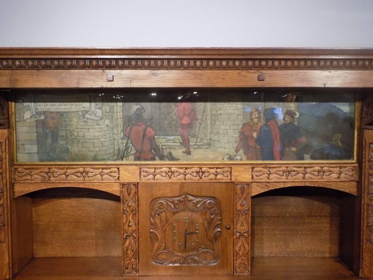 A magnificent and rare Arts & Crafts Period oak fireplace probably by Edgar Wood. The upper section having an overhanging solid oak cornice with egg and dart moulding and exposed tenons with finely carved and stylised corbels and incorporating a