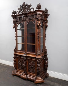 A magnificent fabulously carved antique walnut bookcase in the renaissance style