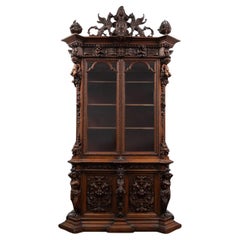 A magnificent fabulously carved antique walnut bookcase in the renaissance style