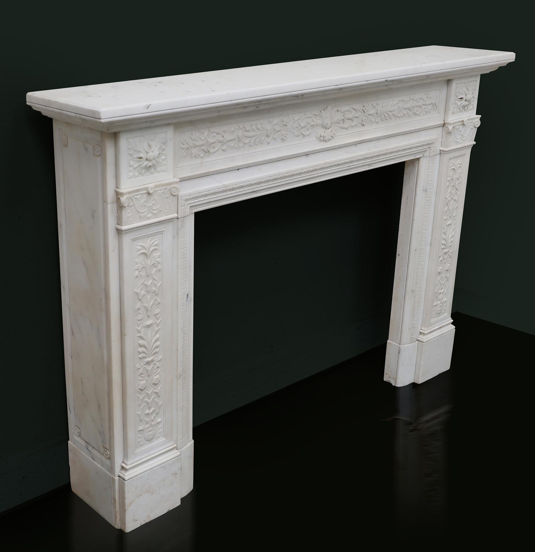 A magnificent finely carved statuary William IV chimneypiece. The moulded shelf sits over a finely carved continuous frieze with central acanthus bloom, harebells and foliage details. The foliate and berry corner blocks, set over scroll and flower