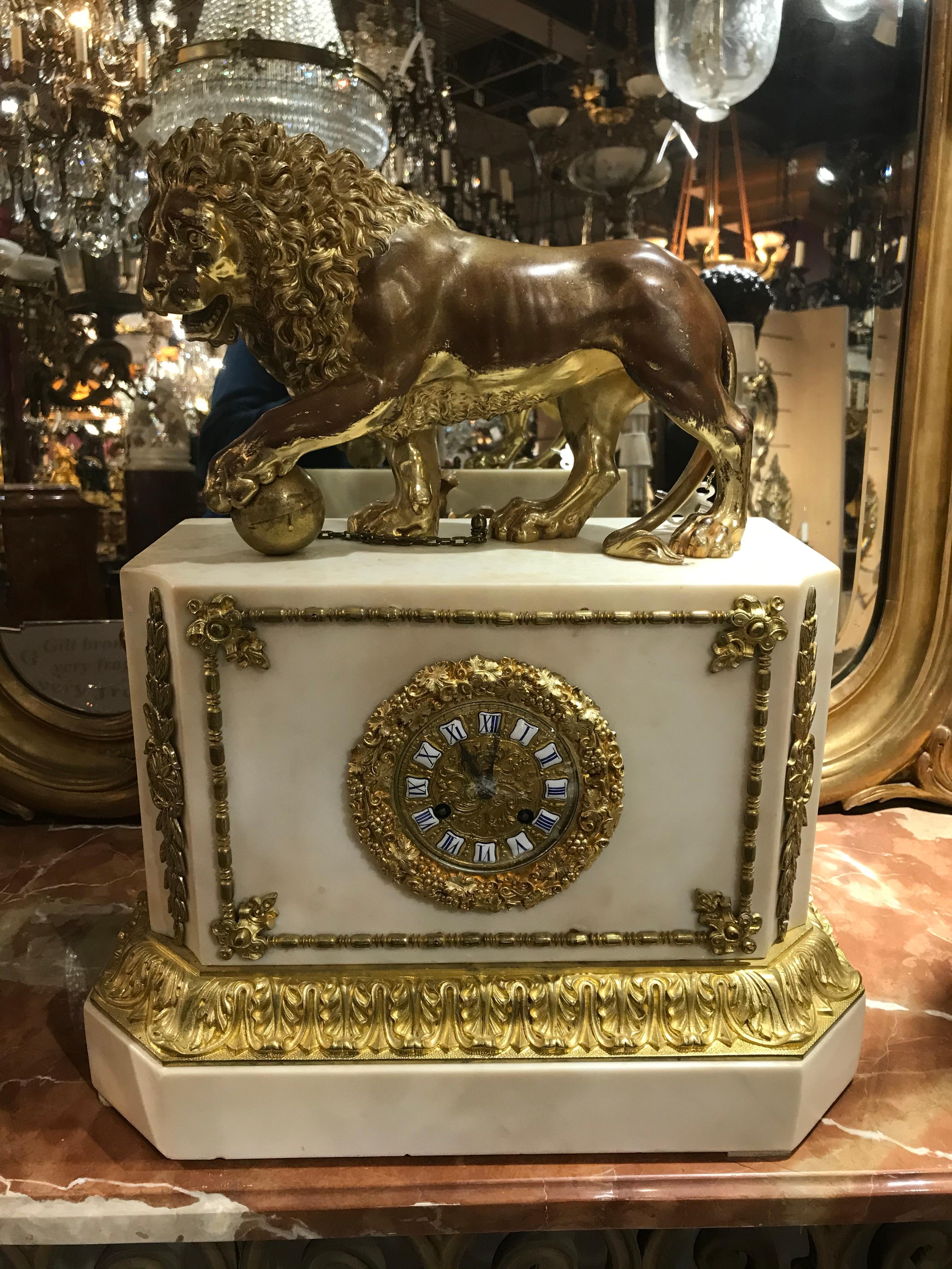 A very fine gilt bronze and marble clock featuring a lion. Marble case, ornate face with enameled Roman numerals. France, circa 1880
Dimensions: Height 21