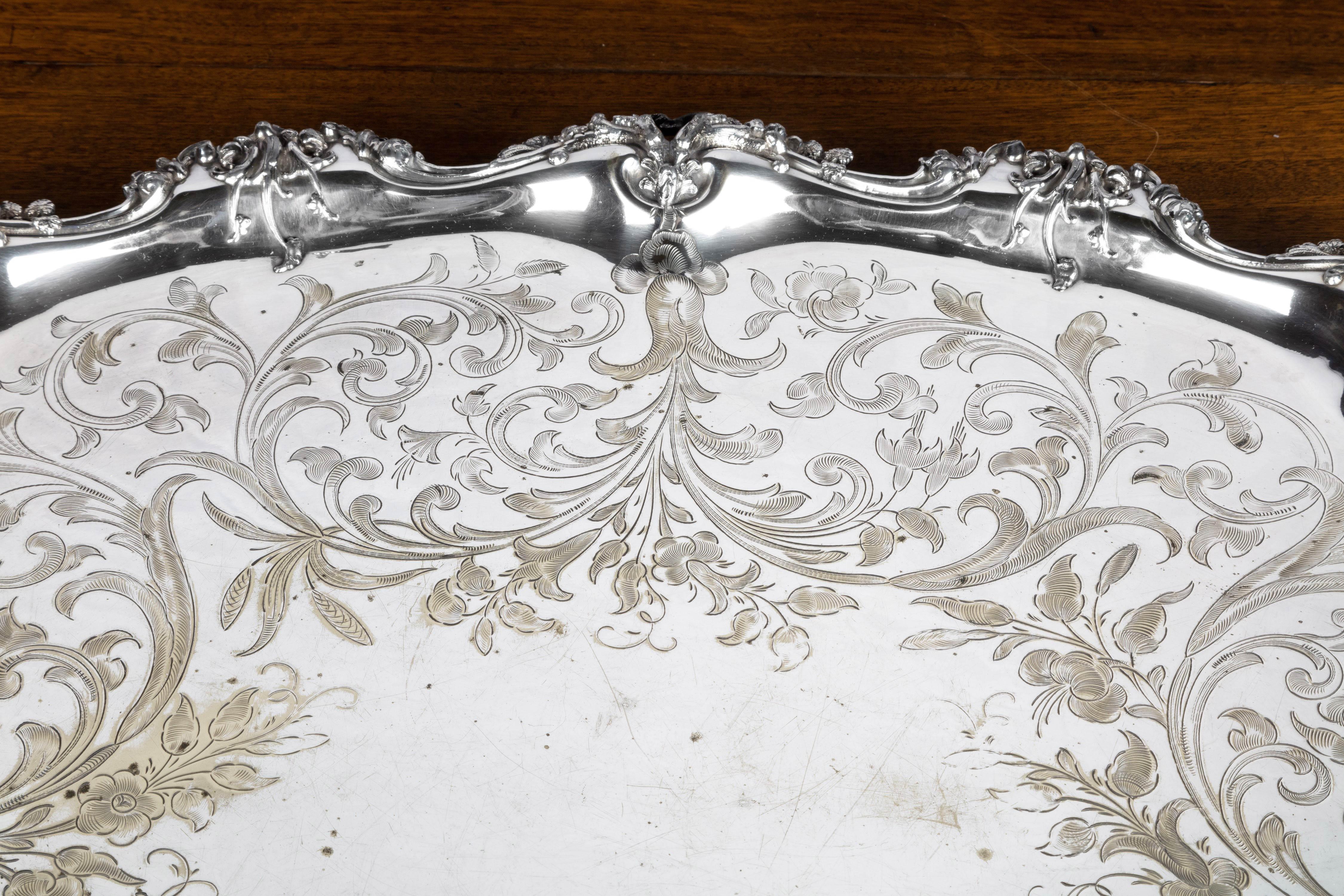 A quite magnificent late Victorian silver plated tray. With an elaborately wavy cast, chiselled and engraved border of foliage. Of the very best quality.