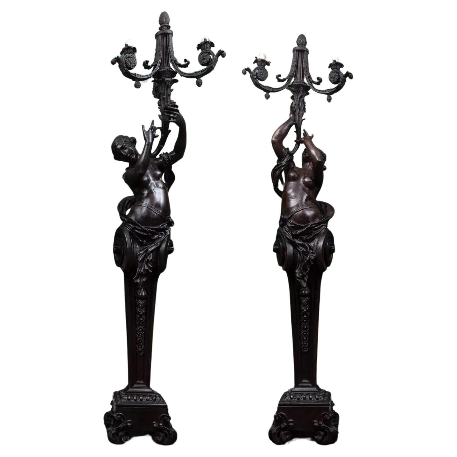 A magnificent pair of free standing female figurative patinated bronze torchère  For Sale