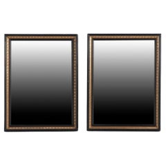 A magnificent pair of French black and gold mirrors, 19th C.