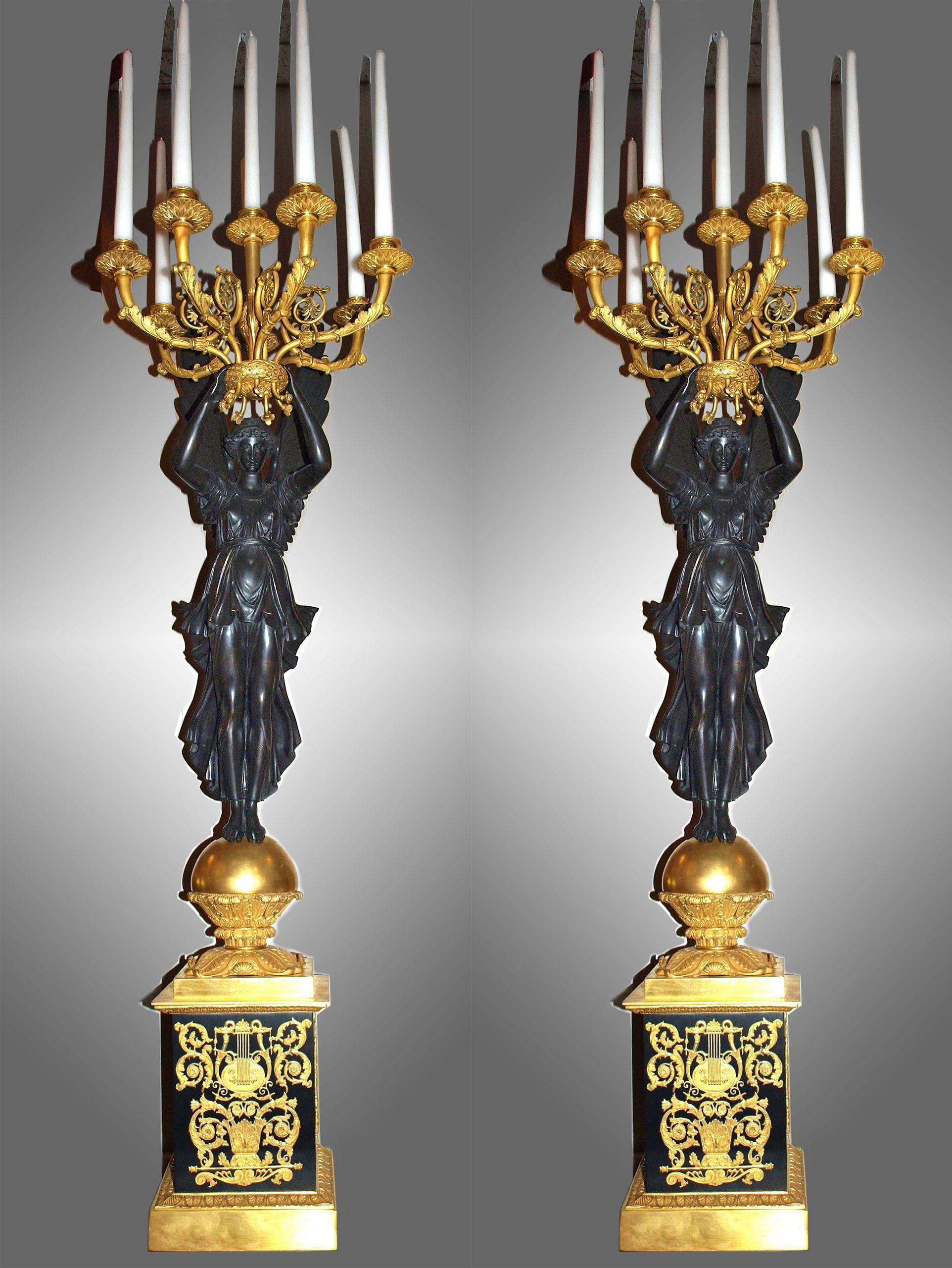 A magnificent pair of gilt bronze with patinated bronze Empire style candelabra. 
France, 19th century. 7 arms each. 
Dimensions: Height 51' excluding candles Base Width: 9