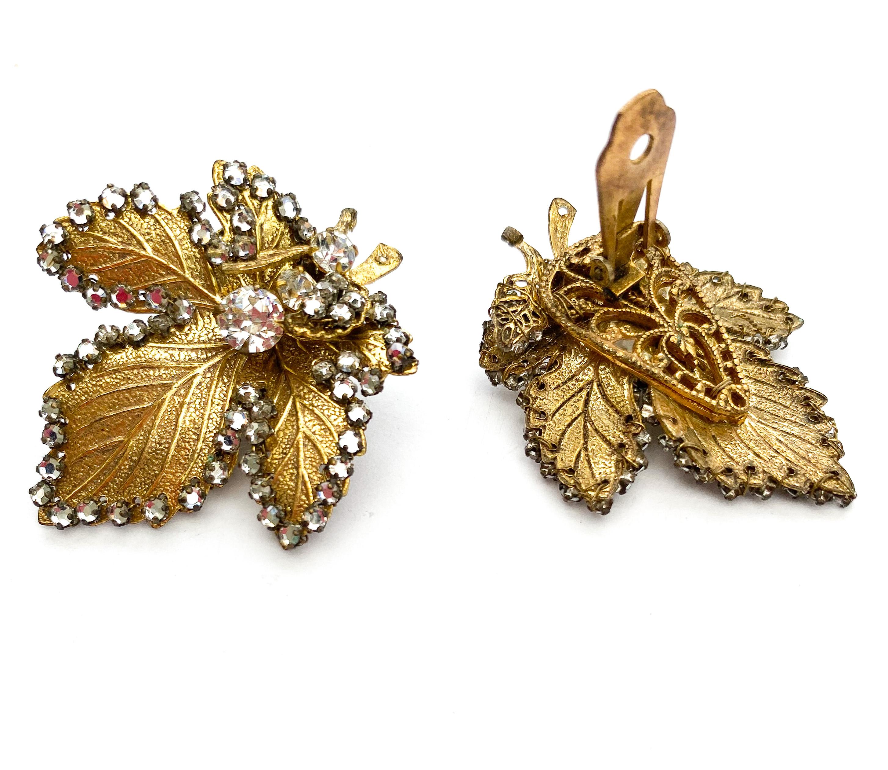 A beautiful and rich gilded metal earring in the form of a sycamore or maple leaf. Designed by Robert Clark for Miram Haskell in the early 1960s, these large, elegant earrings are decorated with rose montes (flat back pastes set on a wire and claw