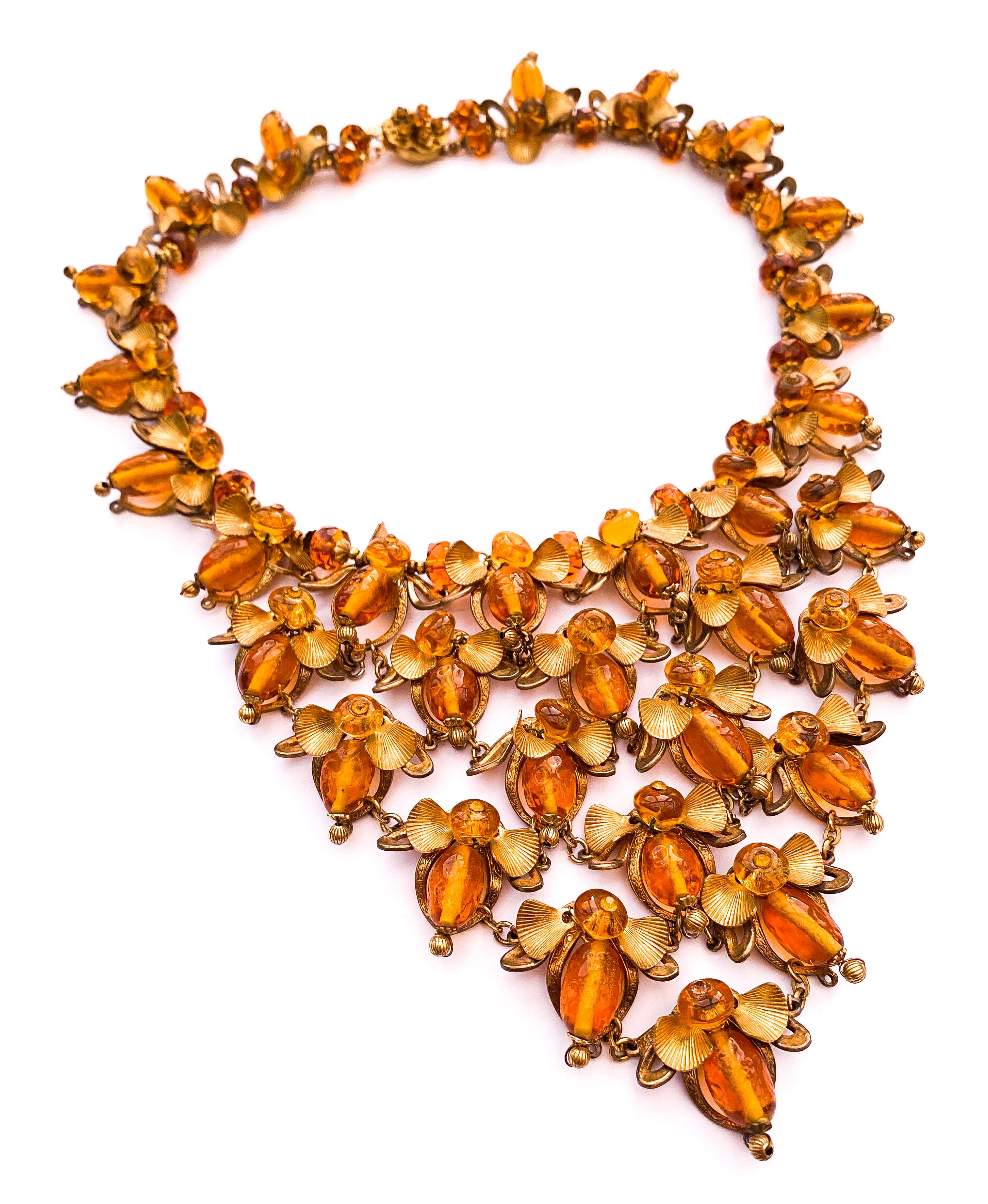 A rare and highly collectable 'bib' necklace, a 'stand out' piece, designed by Robert Clark for Miriam Haskell, a most imaginative and highly unusual design, depicting bees, in the most creative way. The oblong topaz coloured beads were manufactured