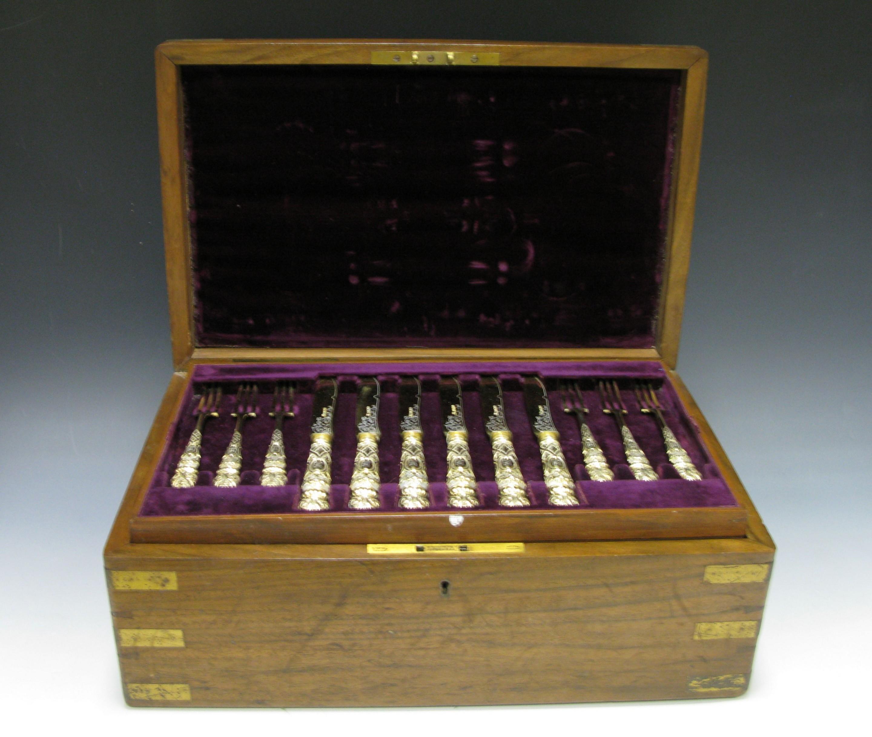 A magnificent antique silver gilt dessert service made by Richard Martin and Ebenezer Hall all contained in the original fitted box. The service has shaped stems and mitre terminals stamped with scrolls, foliage and strap work on a matted ground,