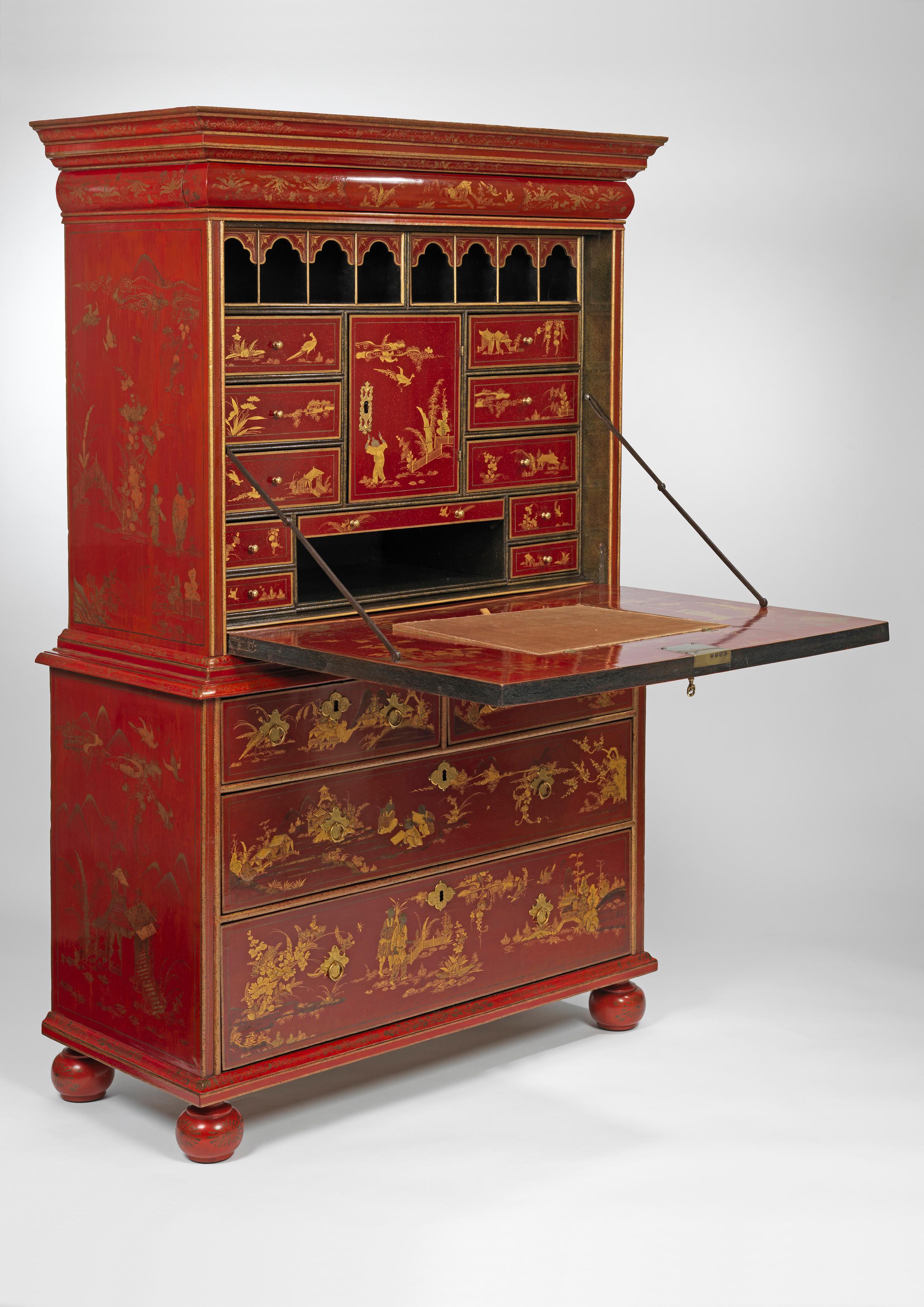 Decorated overall with elaborate chinoiserie scenes depicting figures and fantastical beasts in landscapes amongst scrolling foliage, with a frieze drawer above a fall-front door concealing an arrangement of pigeonholes, drawers, secret