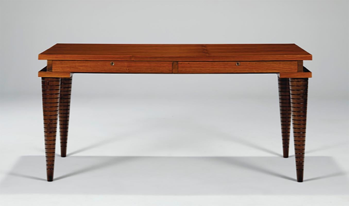 A desk circa 1933 designed by Andre Sornay with his unique brass nailhead inlay. Sapele mahogany with square fluted and tapered legs.