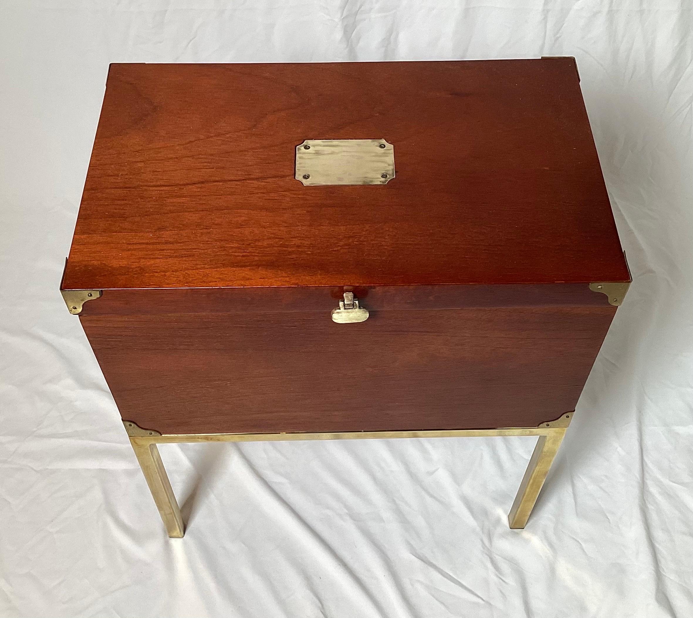 A mahogany campaign style box on stand, The box with brass corners and handles, with attached parson style brass base. The finish in excellent condition.