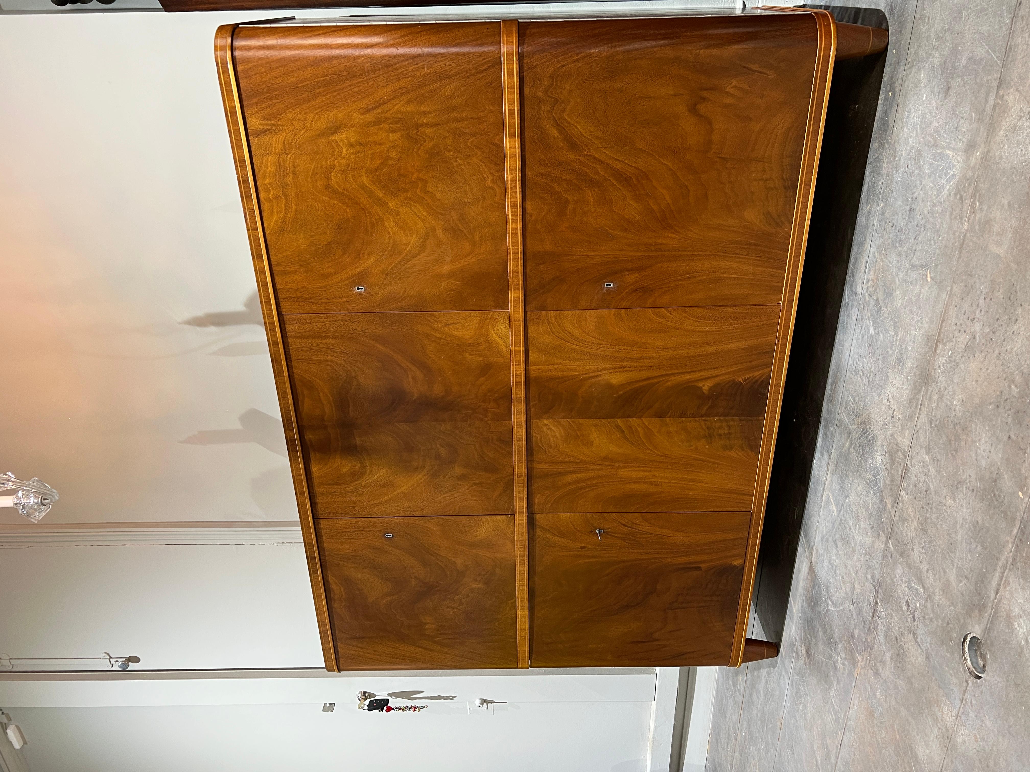 Elegant mahogany cabinet Sweden circa 1940. 
6 doors. 
Shelves and drawers.