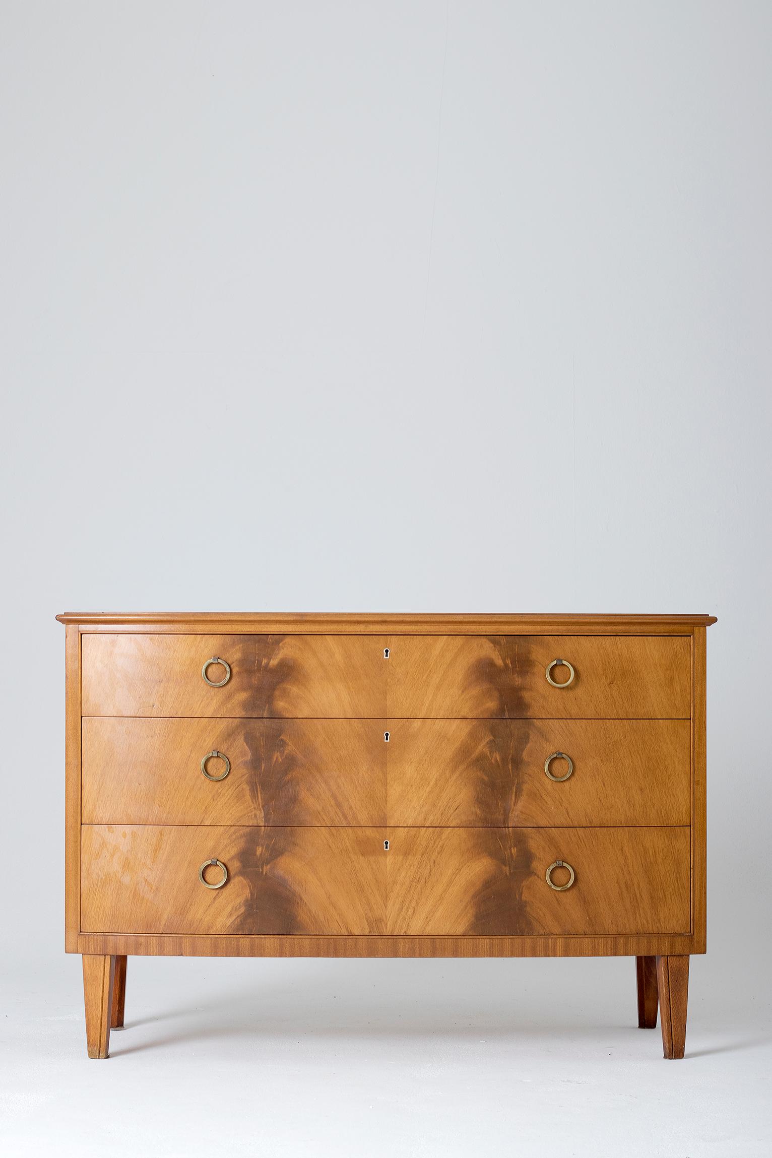 A flamed mahogany chest of drawers, with brass handles, by J. O. Carlssons.
Bearing the maker's label.
Sweden, late 1950s.