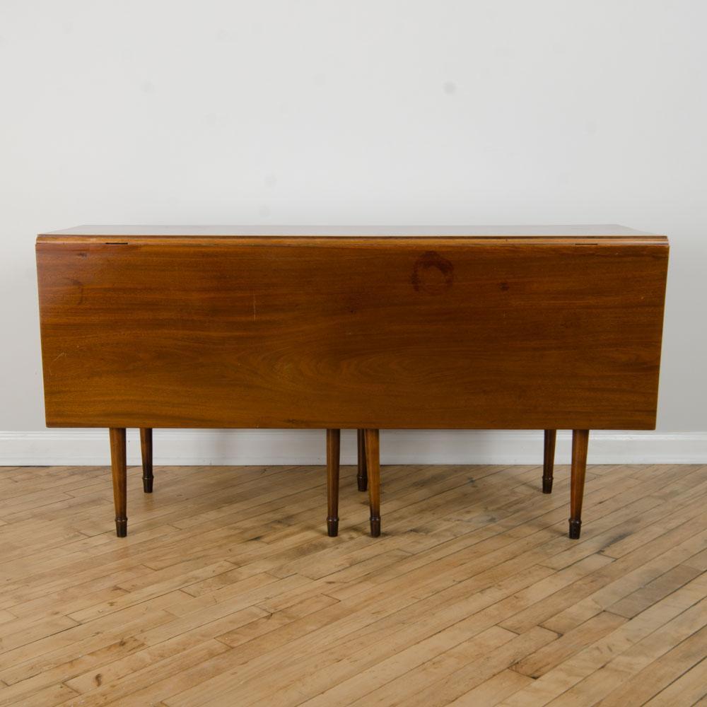 A  solid mahogany drop leaf table six legs. 1950's
Depth when opened is 49.25